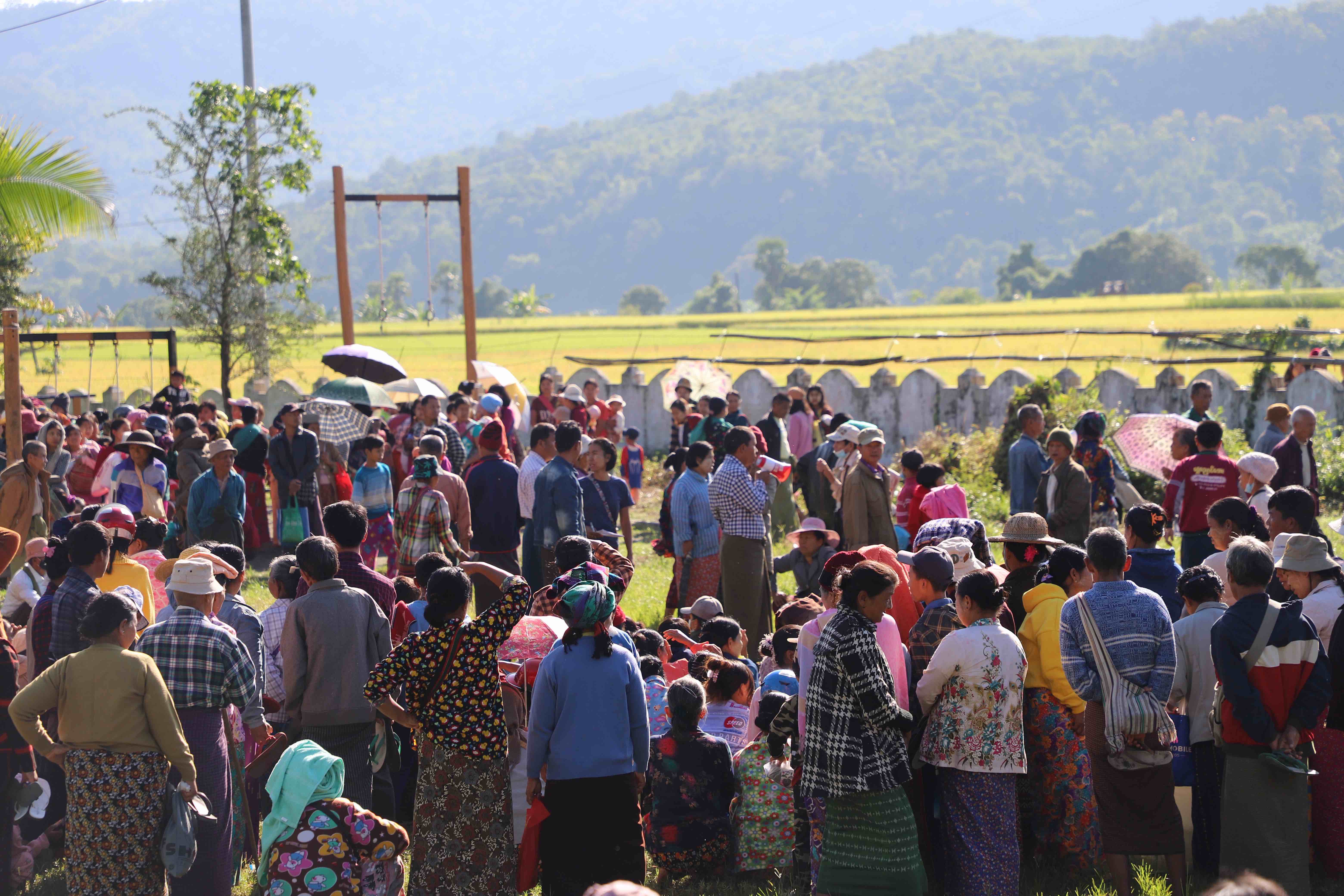 People gather to receive assistance from the Myanmar Red Cross in the Magway region of Myanmar.