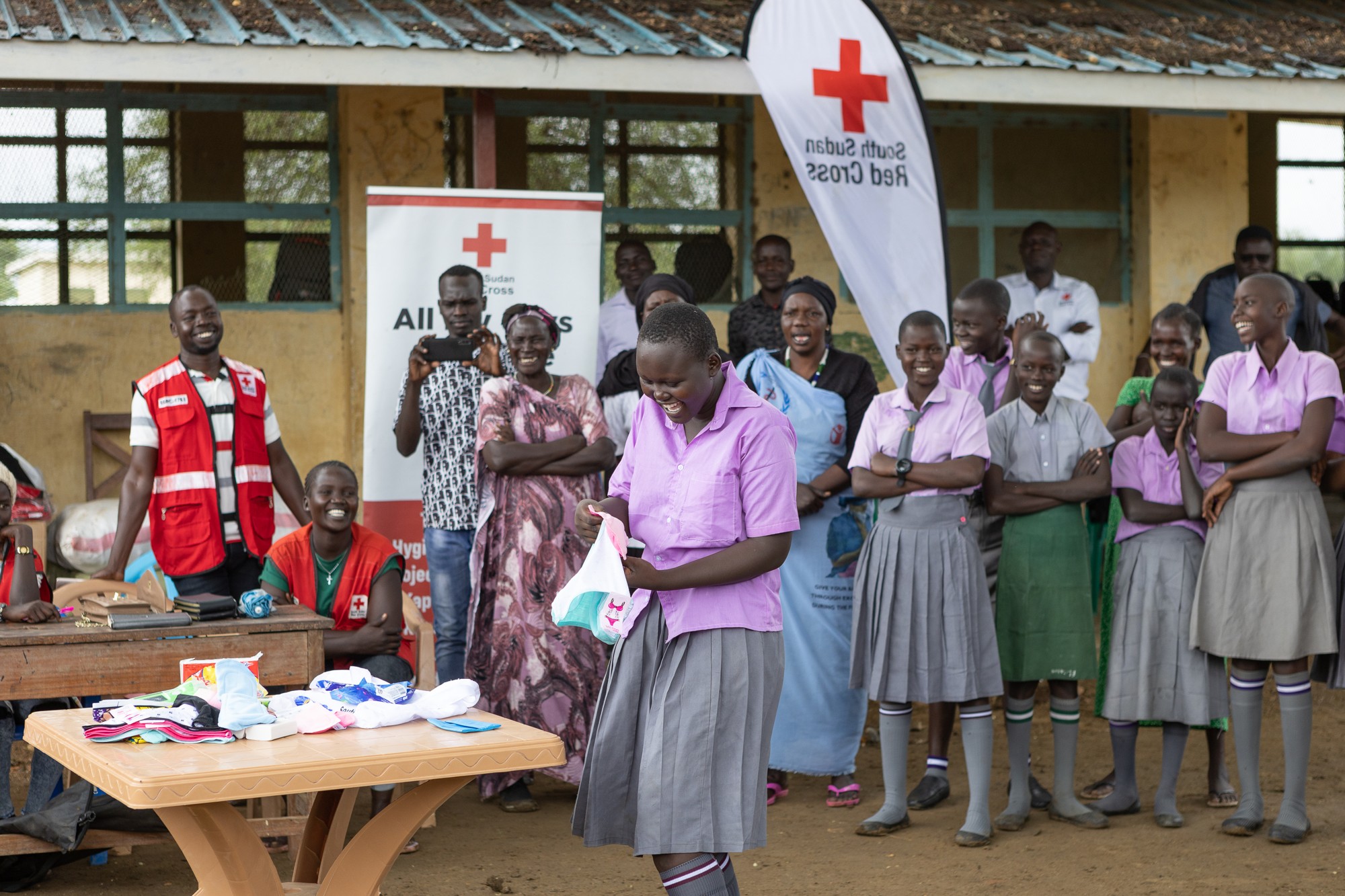 Talking about menstruation can be embarassing because of cultural taboos and sometimes, humor and laughter can help people break through their discomfort. Here, a female student laughs along with classmates as she takes part in the demonstration. 
