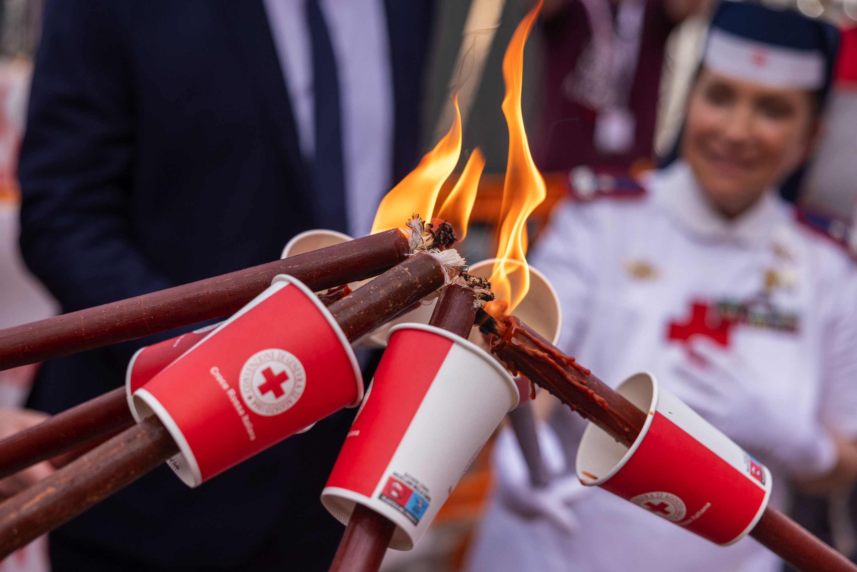 Volunteers light their torches for this year’s procession in Soferino. This year, to spread the light of humanity as far and wide as possible, the IFRC asks everyone to join in and #PassTheTorch via social media.