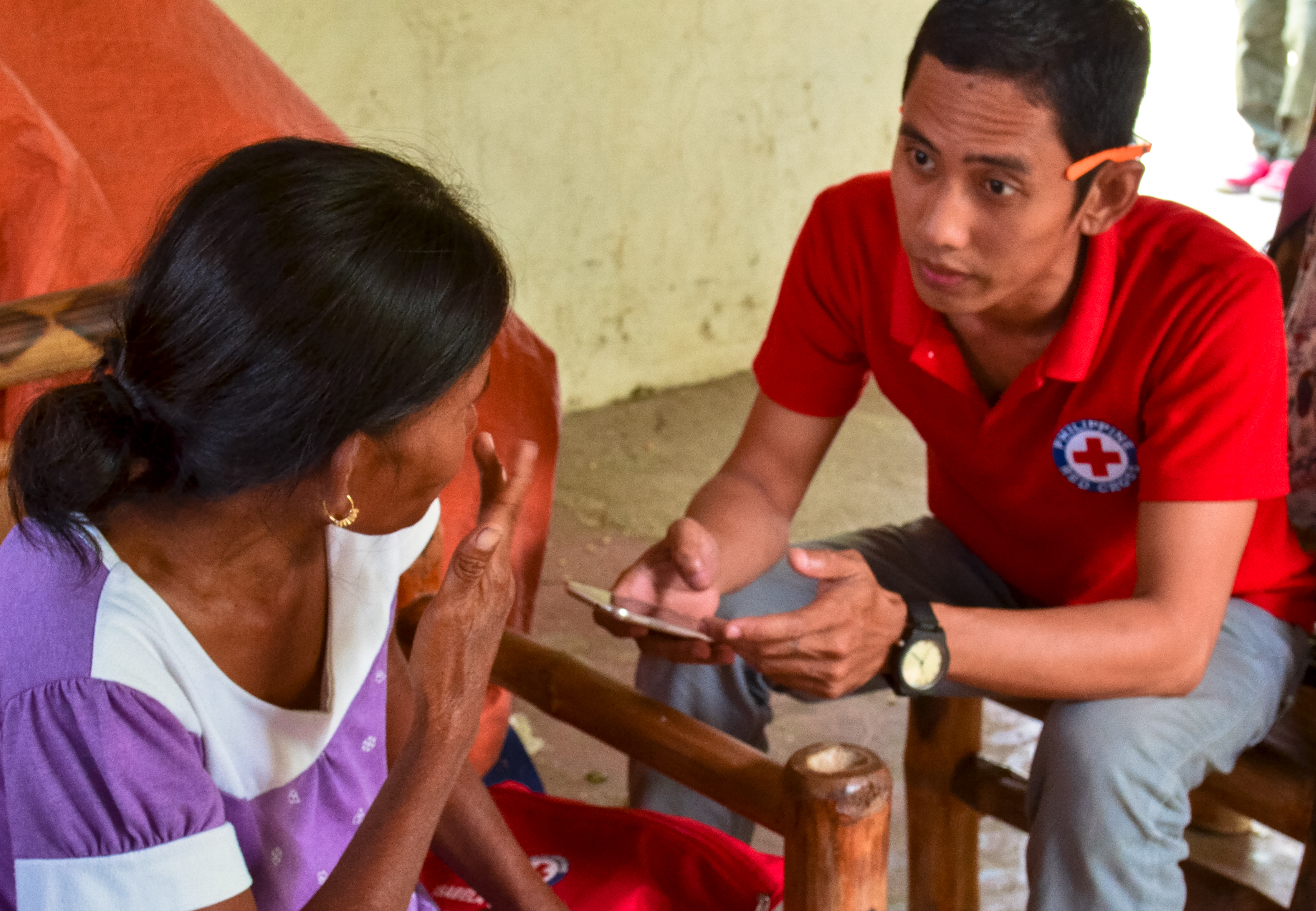 A Philippines Red Cross volunteer uses mobile data collection in the Philippines following Typhoon Mangkhut.