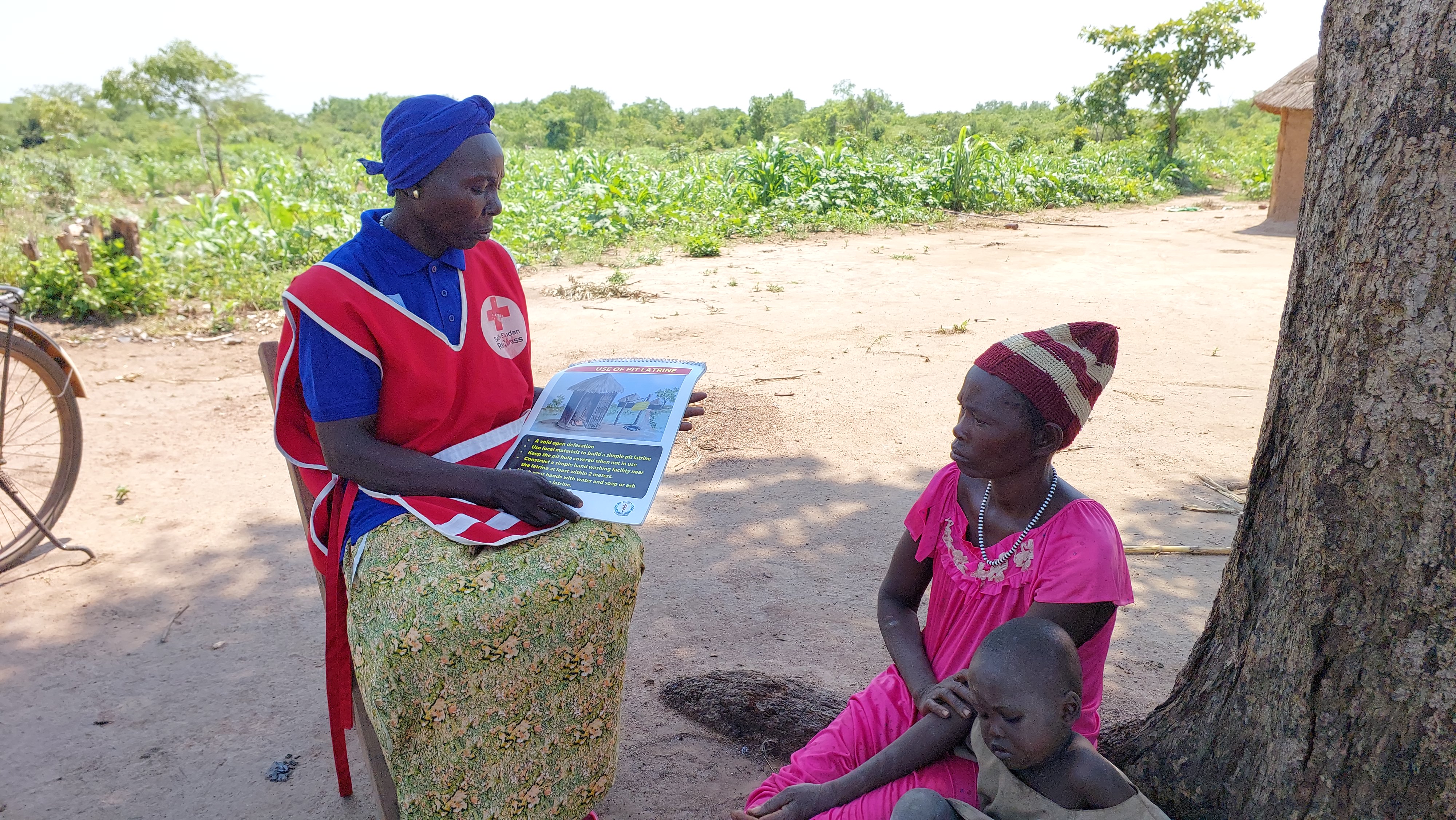 Ajak speaks to villagers about ways to improve their health as part of her work with the REACH initiative.