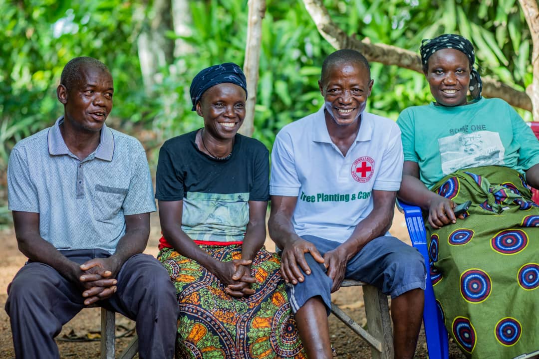 Four participants in the Sierra Leone Red Cross’s Tree Planting and Care initiative share a moment of satisfaction after work. One key objective for the women who take the lead in the project is to mobilize community members to ensure the ongoing care of the trees until they reach maturity.  