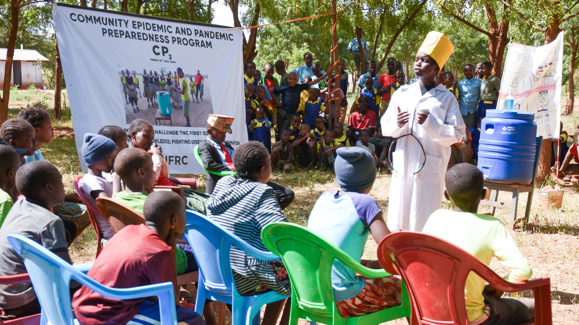 School kids from Tharaka Nithi act out a 'chief baraza' (community meeting) scene where a veterinary doctor delivers important information about rabies and explains why people should vaccinate their animals.