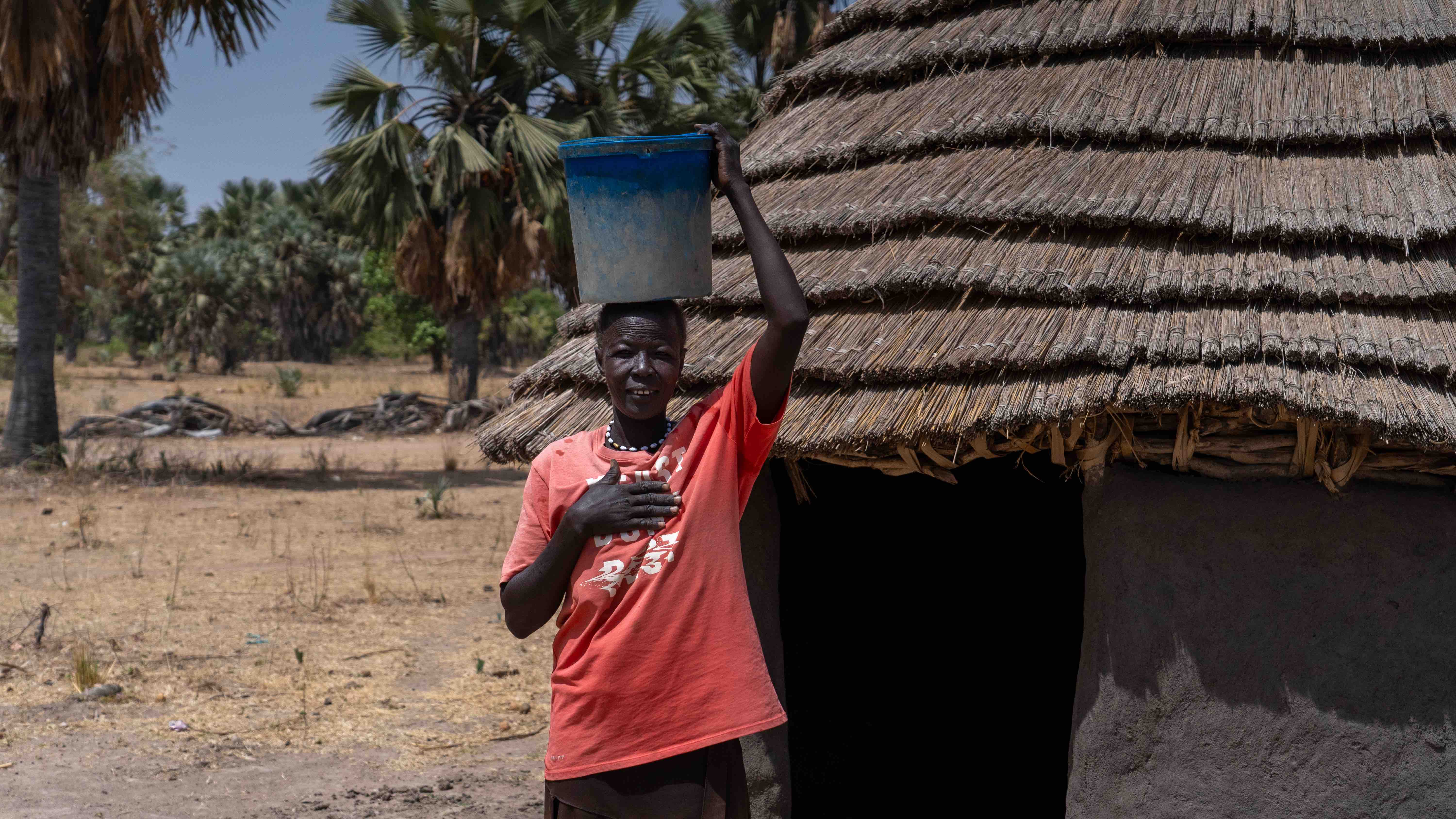 Ayen Mawien Kuol fetches water from the new water pump and brings it back to her home in the county of Aweil South in South Sudan.
