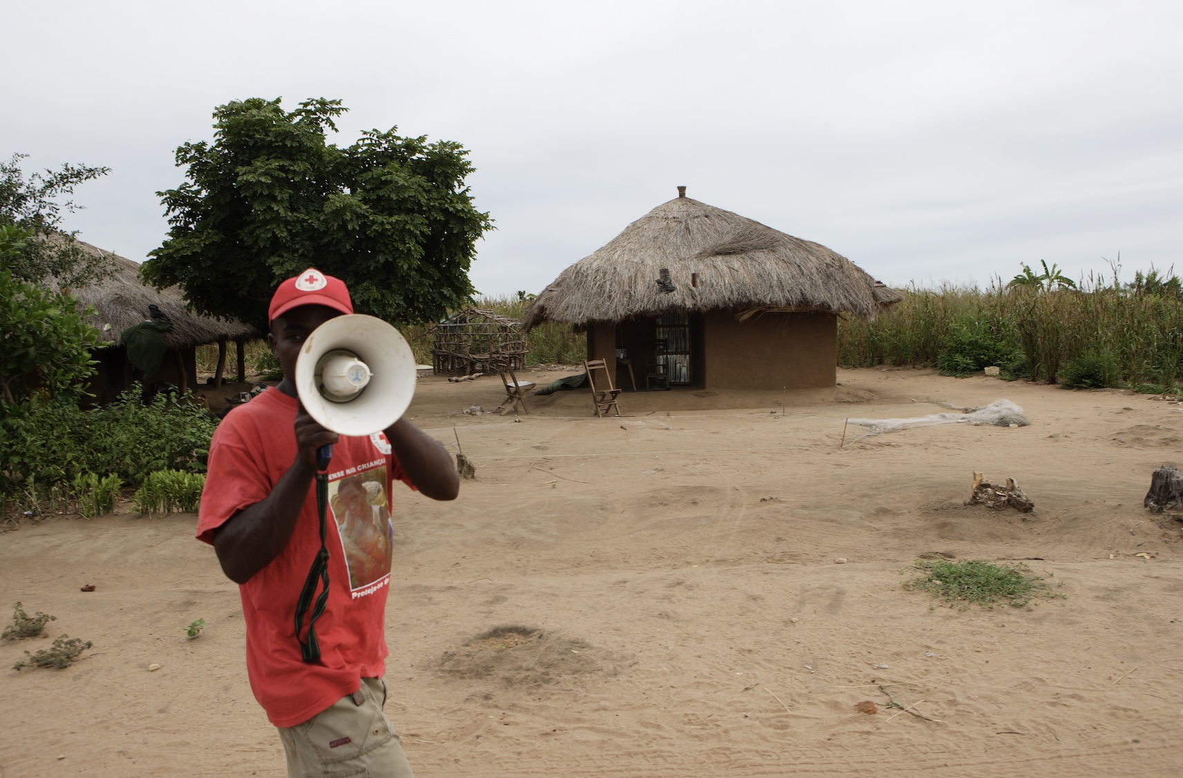 A volunteer with the Mozambique Red Cross takes part in an early warning drill as part of efforts to prepare local communities for potential crises.