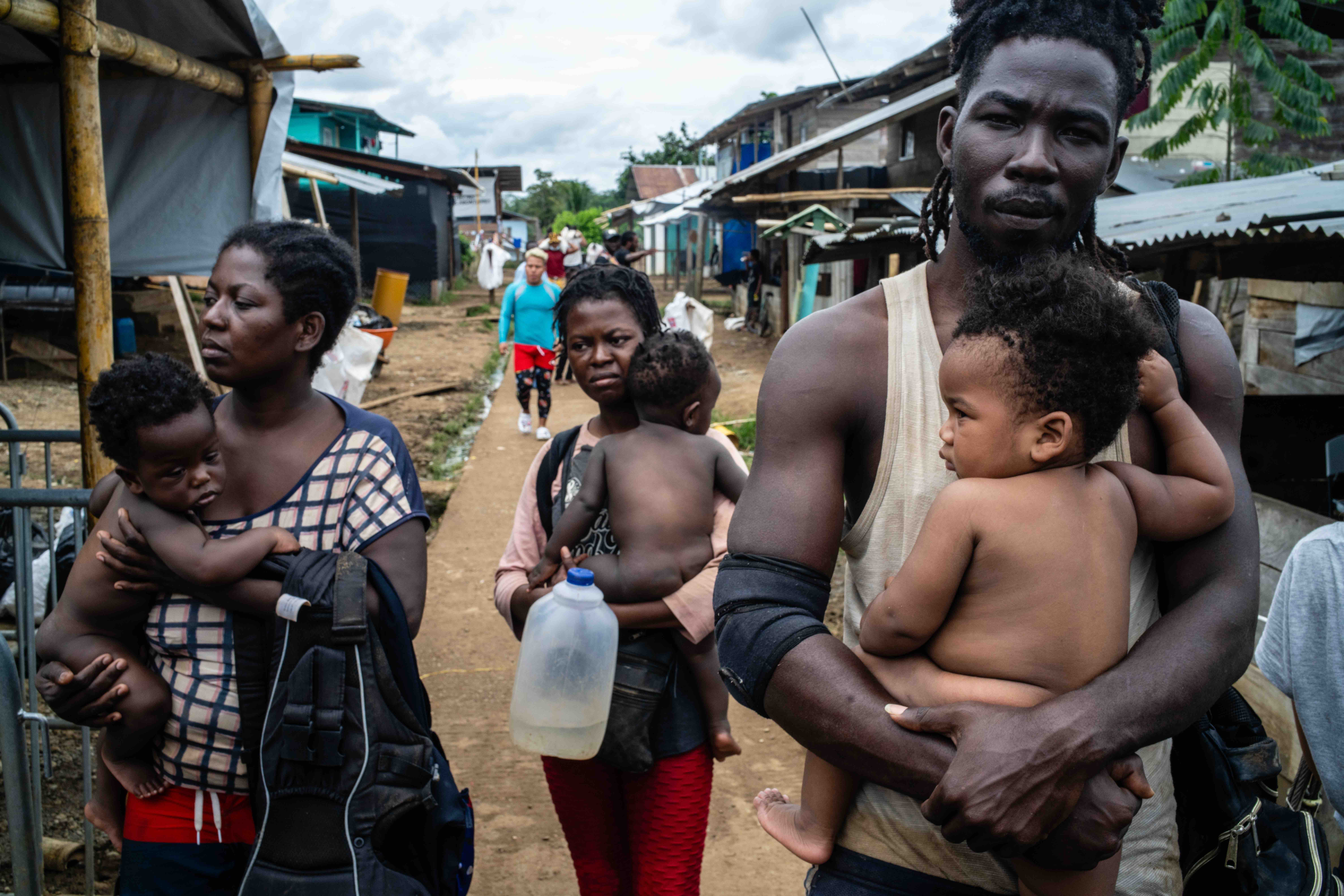 In this photo, a group of people from Haiti walk through the streets of Bajo Chiquito, Panama – one of the first towns people reach after crossing the Darién.