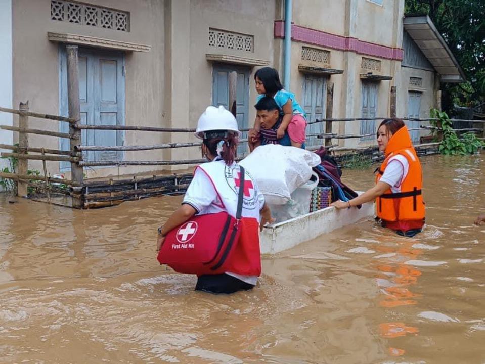 Volunteers from the Myanmar Red Cross mobilize to help people displaced from an urban neighbourhood by severe flooding.