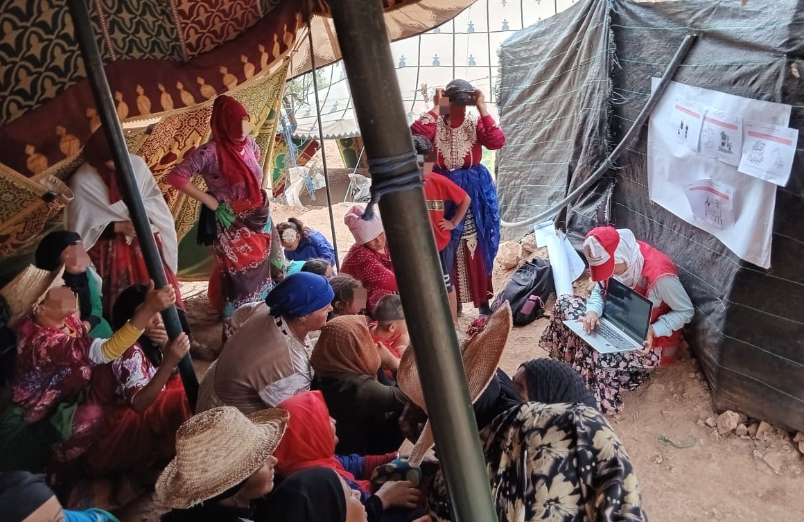 Naima offers a presentation of the temporary shelter programme and selection criteria to women of the community of Tighoula.
