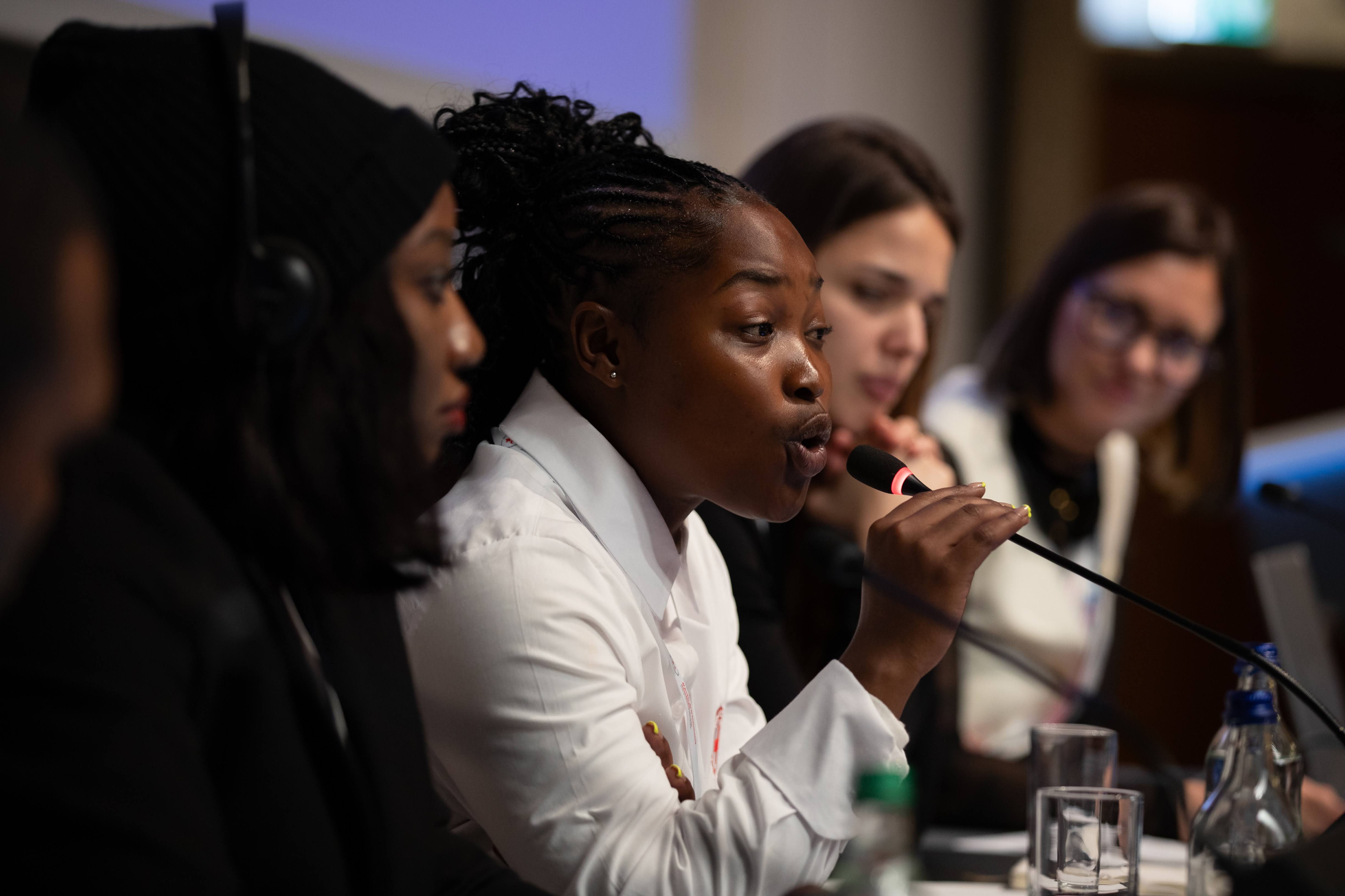 A participant in the IFRC Youth Forum makes a point during a panel discussing the IFRC Youth Engagement Strategy