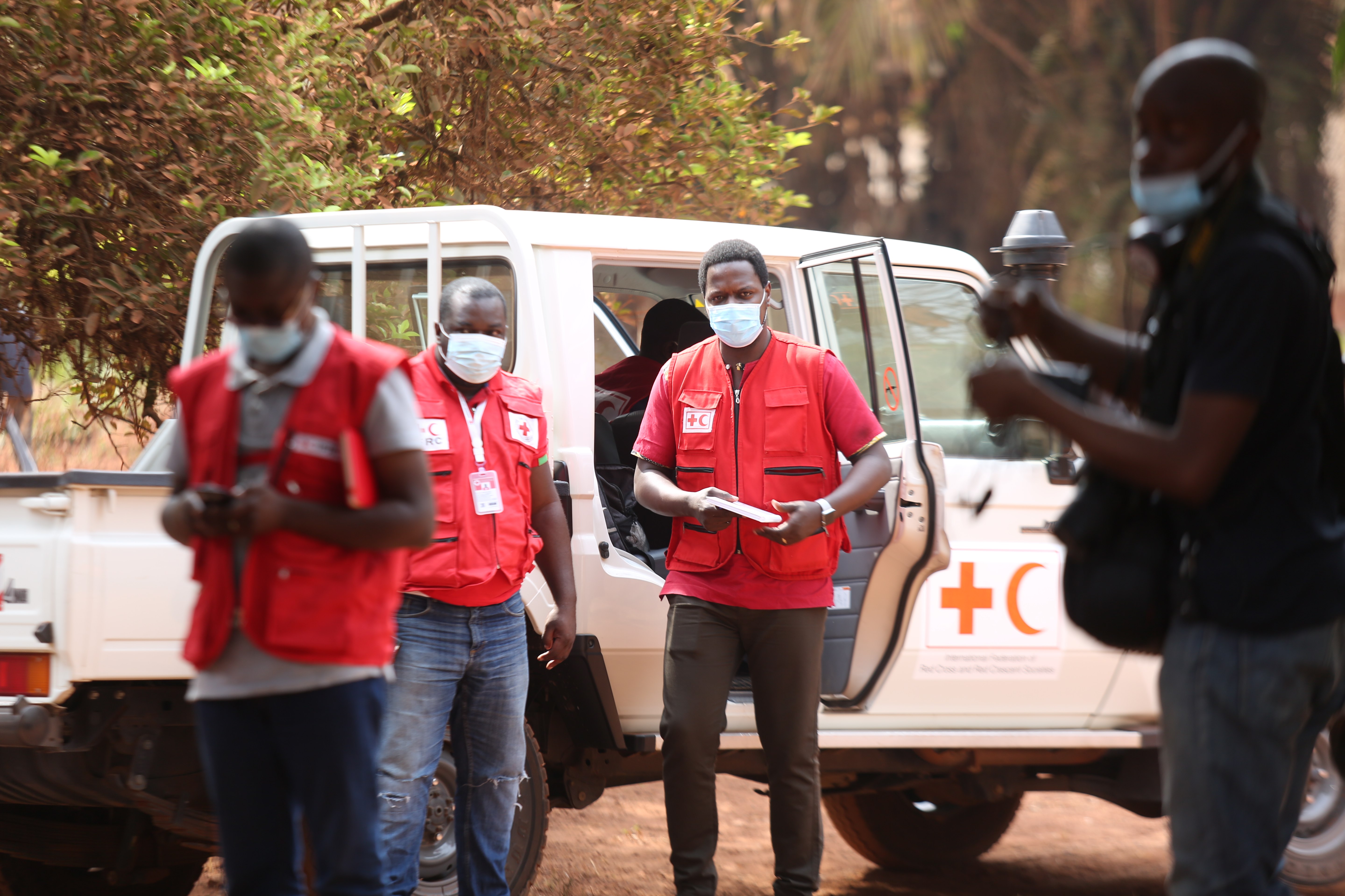 Dr. Aimé Mbonda, regional IFRC Health Coordinator based in Yaoundé, Cameroon, makes a community visit with volunteers during the Covid-19 pandemic.