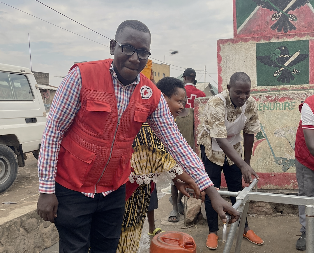Burundi Red Cross volunteer Christopher Hatungimana at a recently installed water point, which has reinforced the community’s ability to stop the spread of mpox.