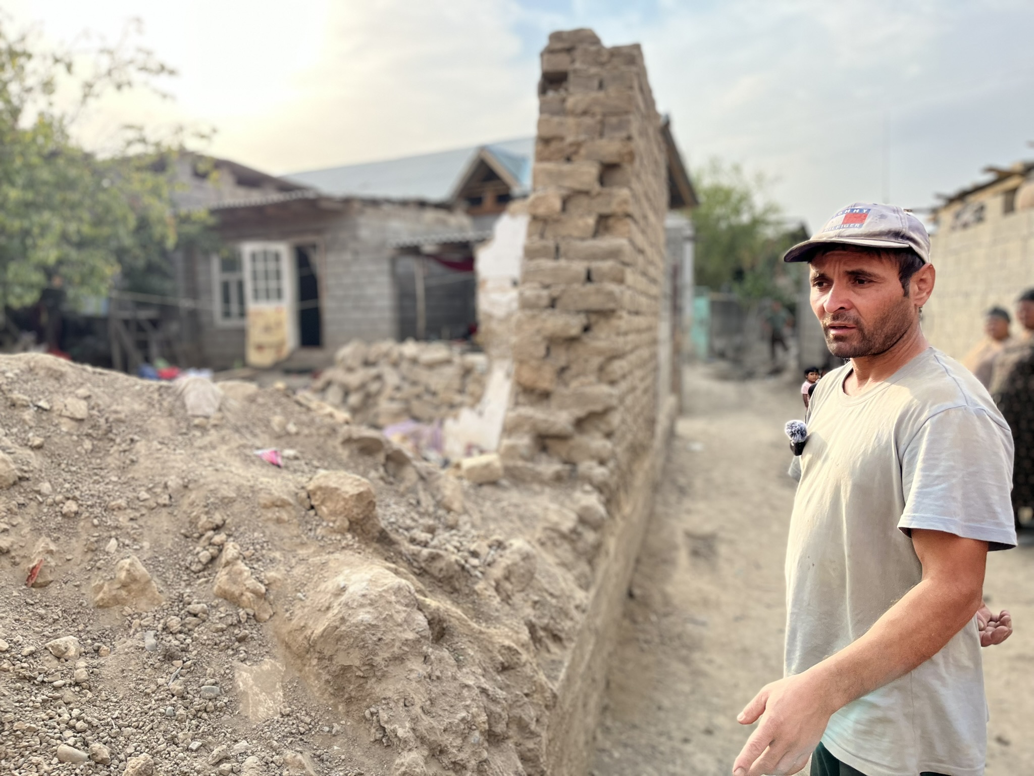 In the Roma village in Osh, Kyrgyzstan, a man stands next to what is left of his home. Made from traditional clay bricks, his house was washed away after a nearby river flooded the village in July, destroying and damaging many homes.&nbsp;