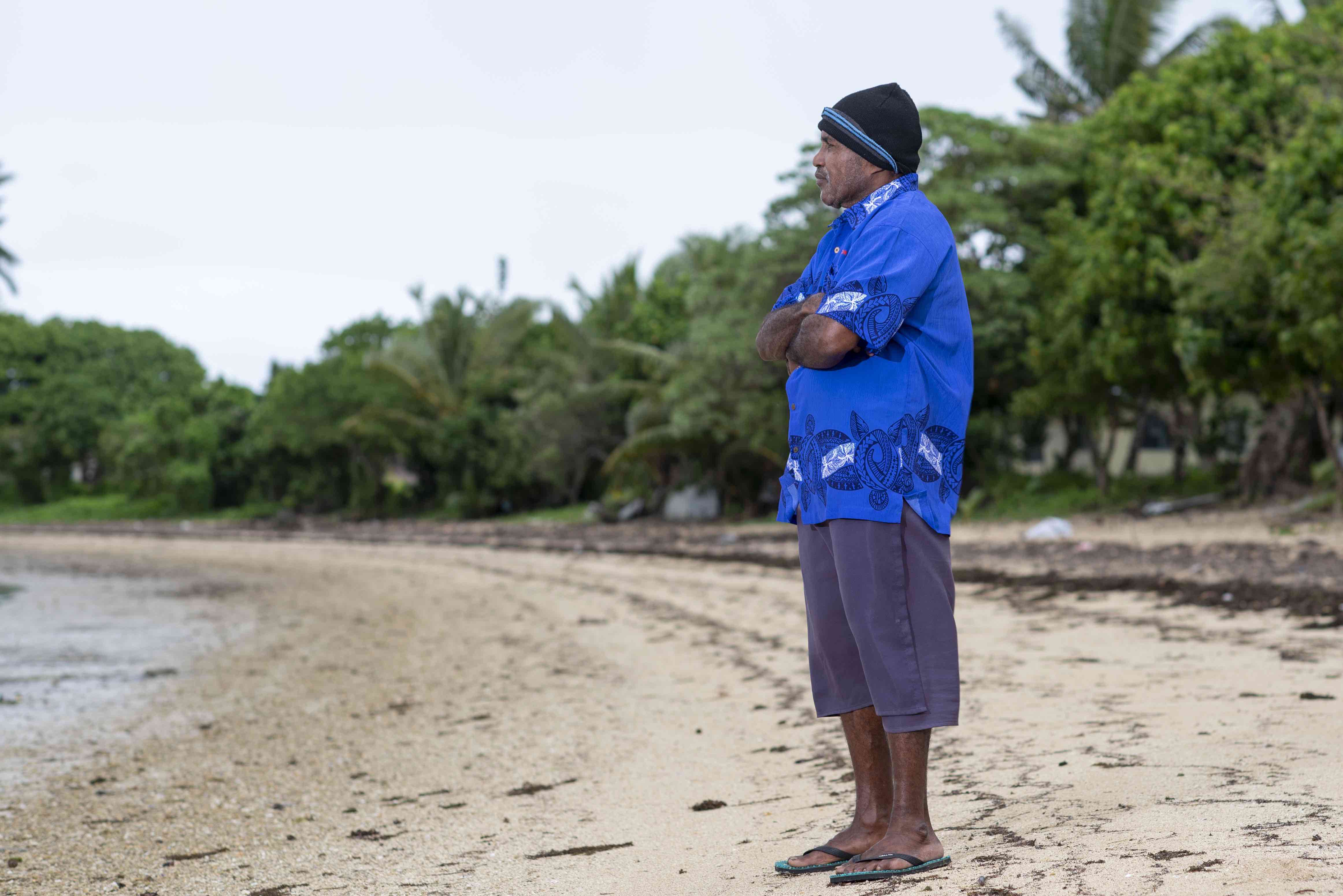 Seru Ramakita, 61, stands on the beach near the village of Navuevu, where he was born and raised and where climate change is causing frequent serious flooding well outside normal weather patterns. 