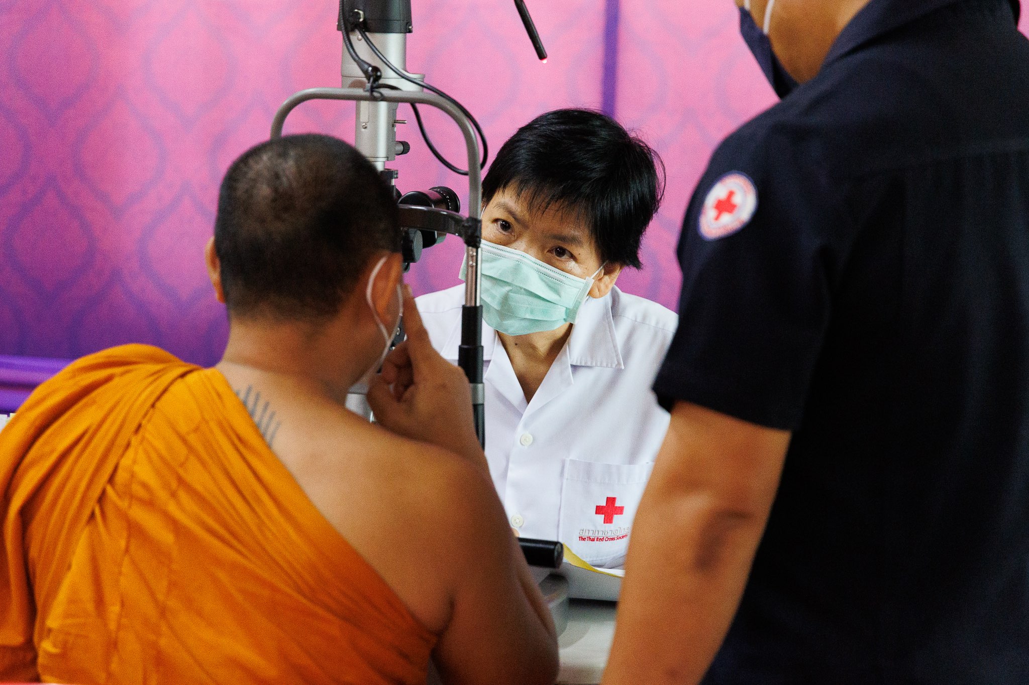 Ophthalmologist Dr Uraiwan Tinnungwattana conducts an eye exam as part of her work for the Medical Service Unit of the Thai Red Cross Society, where she has pioneered efforts to bring eye care to marginalized communities.