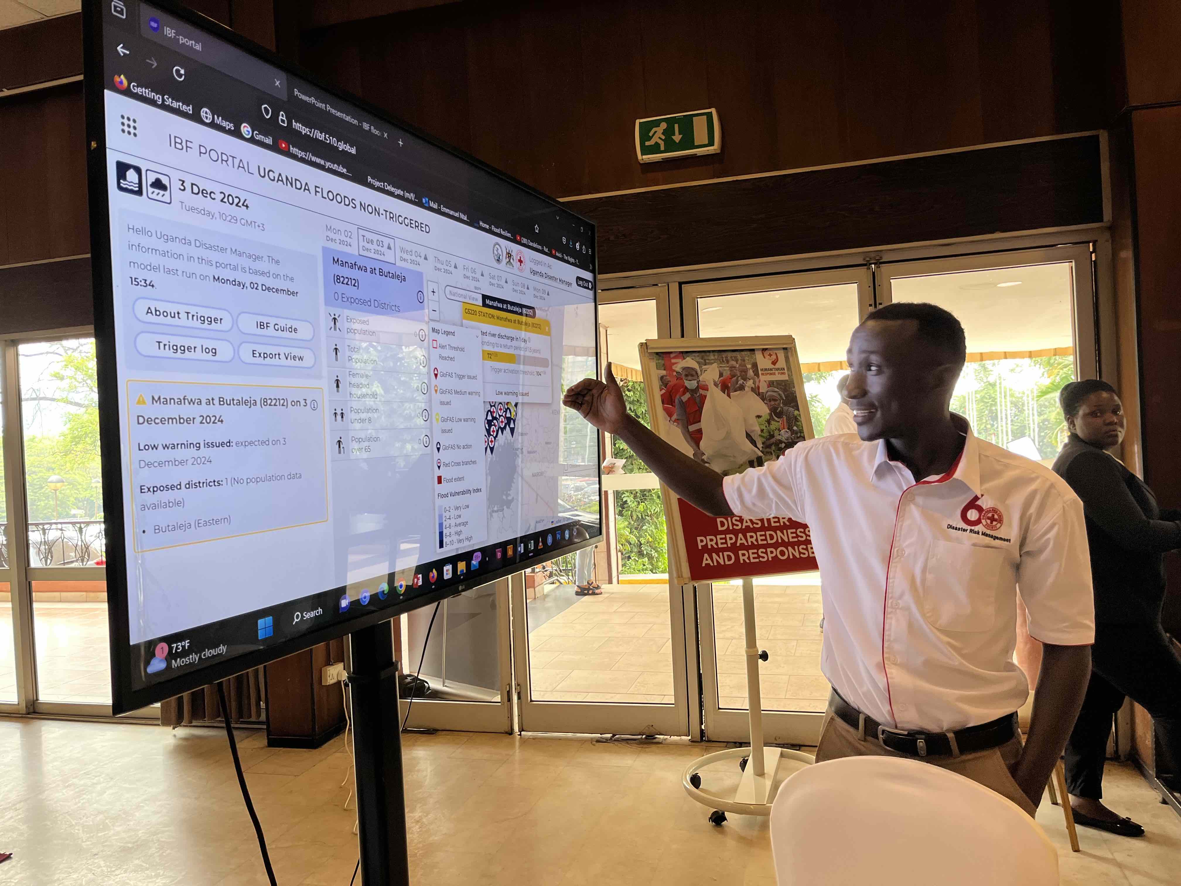 Emmanuel Ntale, the Anticipatory Action focal point of Uganda Red Cross Society, analyses the data provided in the Impact-Based Forecasting Portal, using weather forecasts to predict and reduce the worst impacts of climate events such as floods.