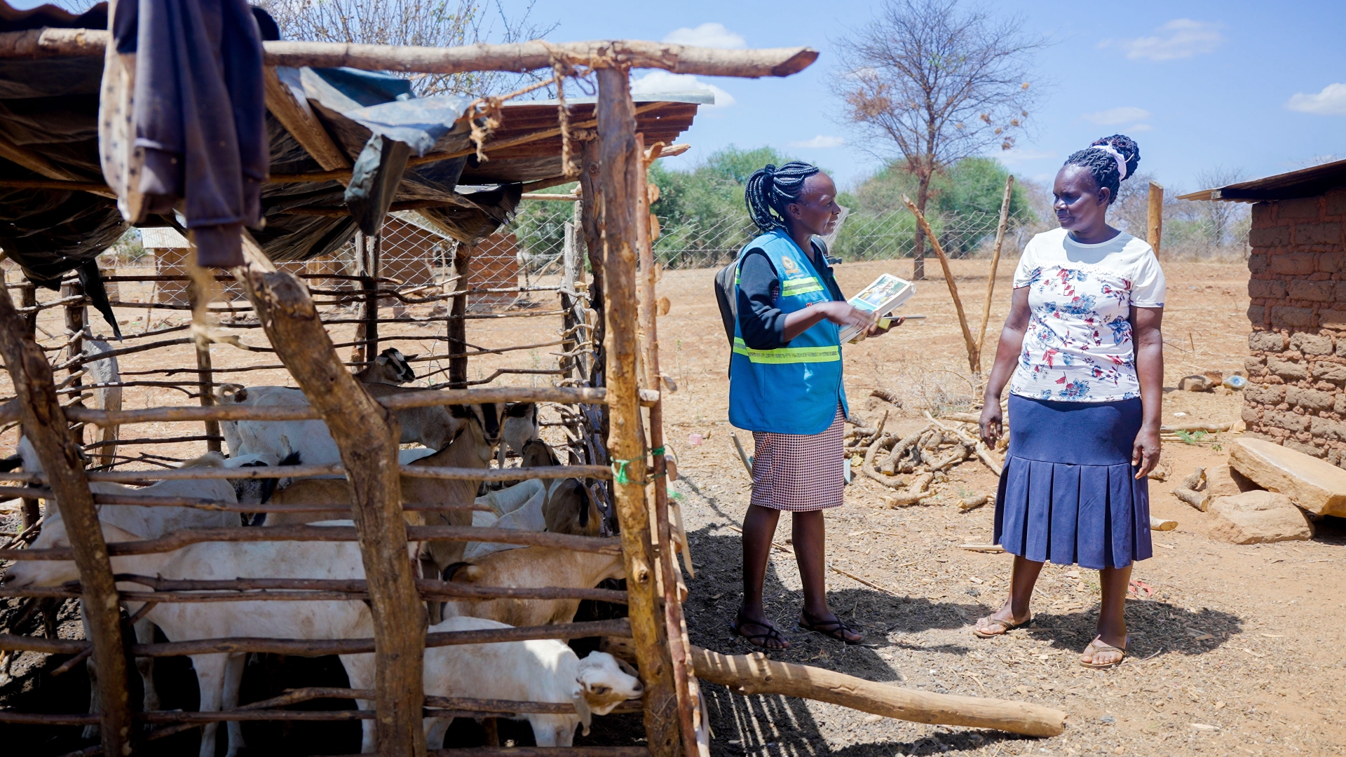 A Kenya Red Cross volunteer with the Community Epidemic and Pandemic Preparedness Programme (CP3) speaks to a woman in Tharaka Nithi about different disease risks and how to stay healthy and safe. 