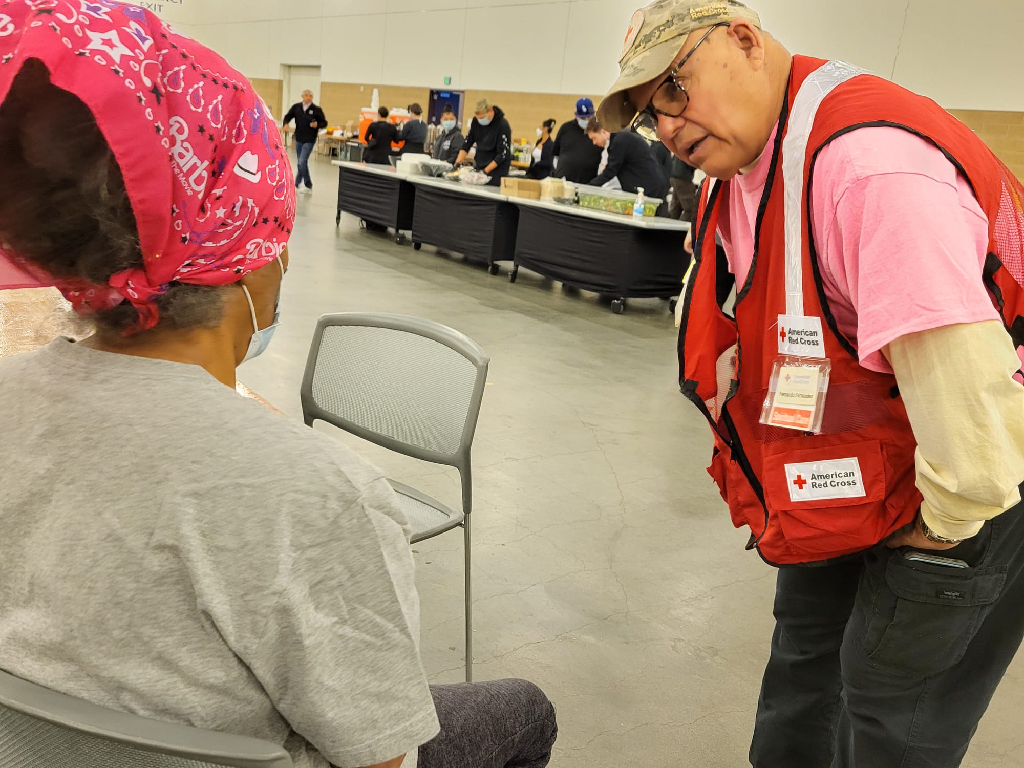 A Red Cross volunteer from Texas, Fernando Fernández checks in with a woman who lost her home to the fires. Fernández traveled hundreds of miles to California to offer emotional support to evacuees. 