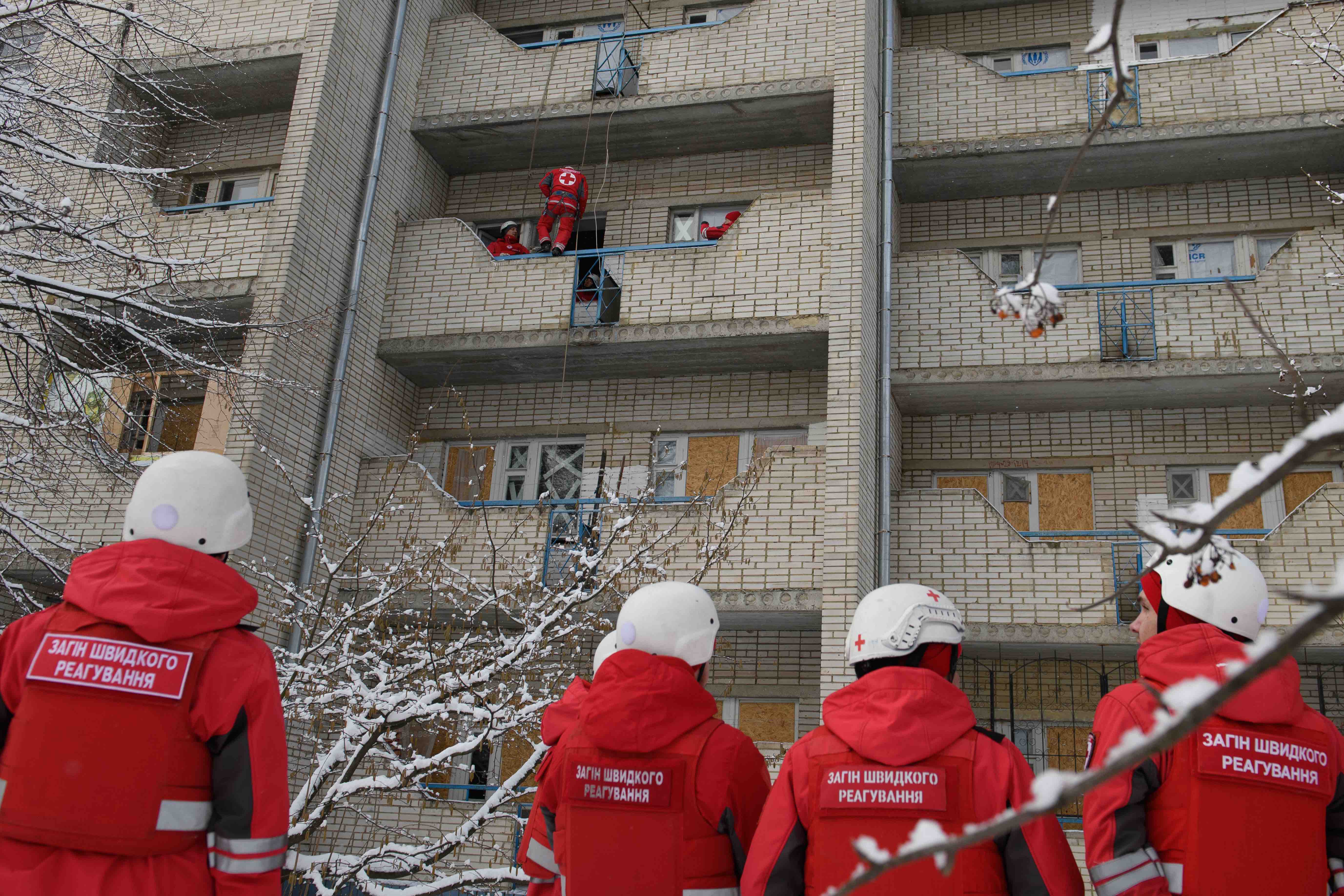 Members of a Ukrainian Red Cross emergency response unit taking part in a training exercise for evacuating people with limited mobility from the upper floors of apartment buildings.
