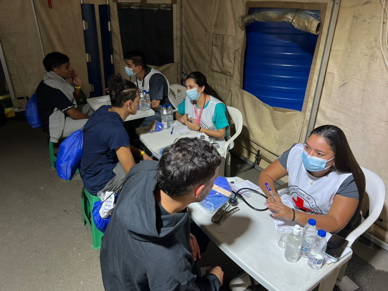 Staff and volunteers for the Venezuelan Red Cross provide health check ups and other humanitarian assistance to Venezuelan migrants who have recently been returned to the country. 