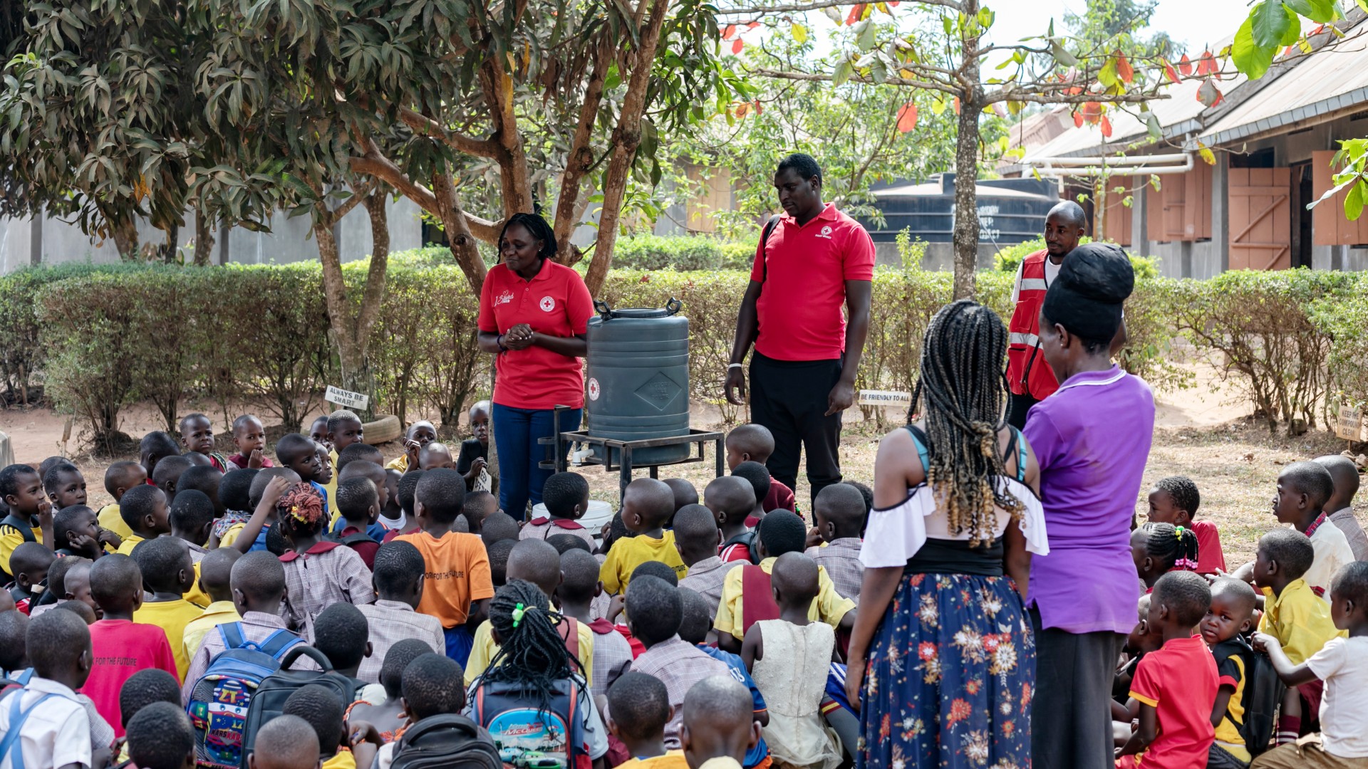 Uganda Red Cross Society volunteers install a new handwashing point at a school in Wakiso district in early March 2025, teaching pupils about good hygiene to help them reduce their risks of Ebola and mpox.