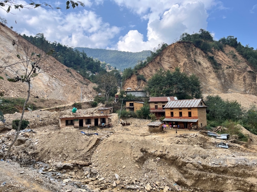 Houses that were once surrounded by green fields, kitchen gardens and trees, now stand shattered amid a field of destruction and rubble.  