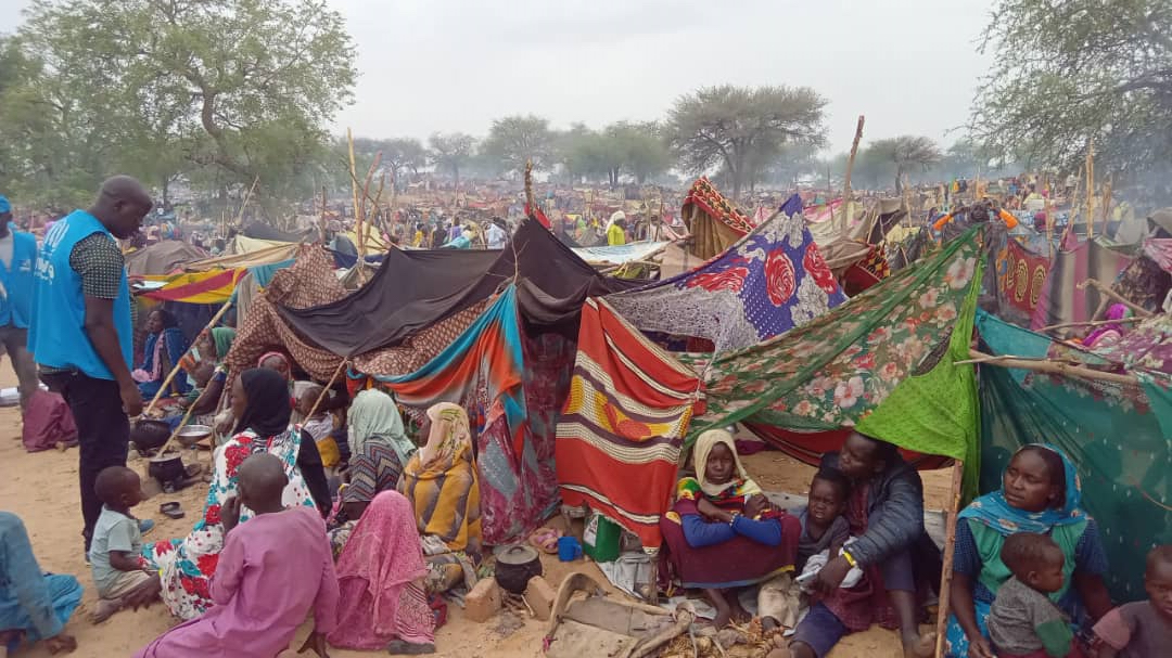 Sudanese refugees who sought safety in Chad after fleeing from conflict in Merowe town, Sudan, gather around makeshift tents and shelters.