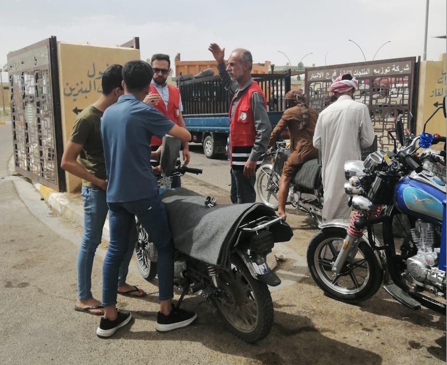 Iraqi Red Crescent volunteers take their message to the street as they talk to motorcycle riders and raise awareness about how to avoid the dangerous health effects of extreme heat.