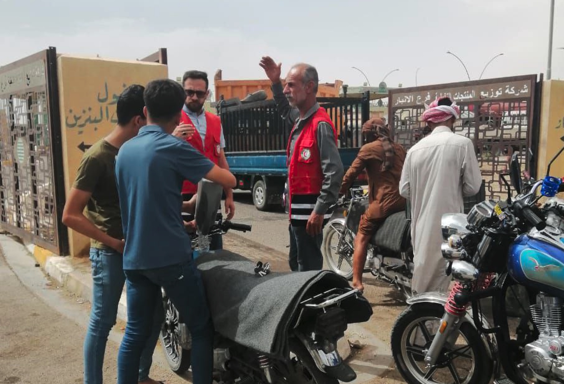 Iraqi Red Crescent volunteers take their message to the street as they talk to motorcycle riders and raise awareness about how to avoid the dangerous health effects of extreme heat.