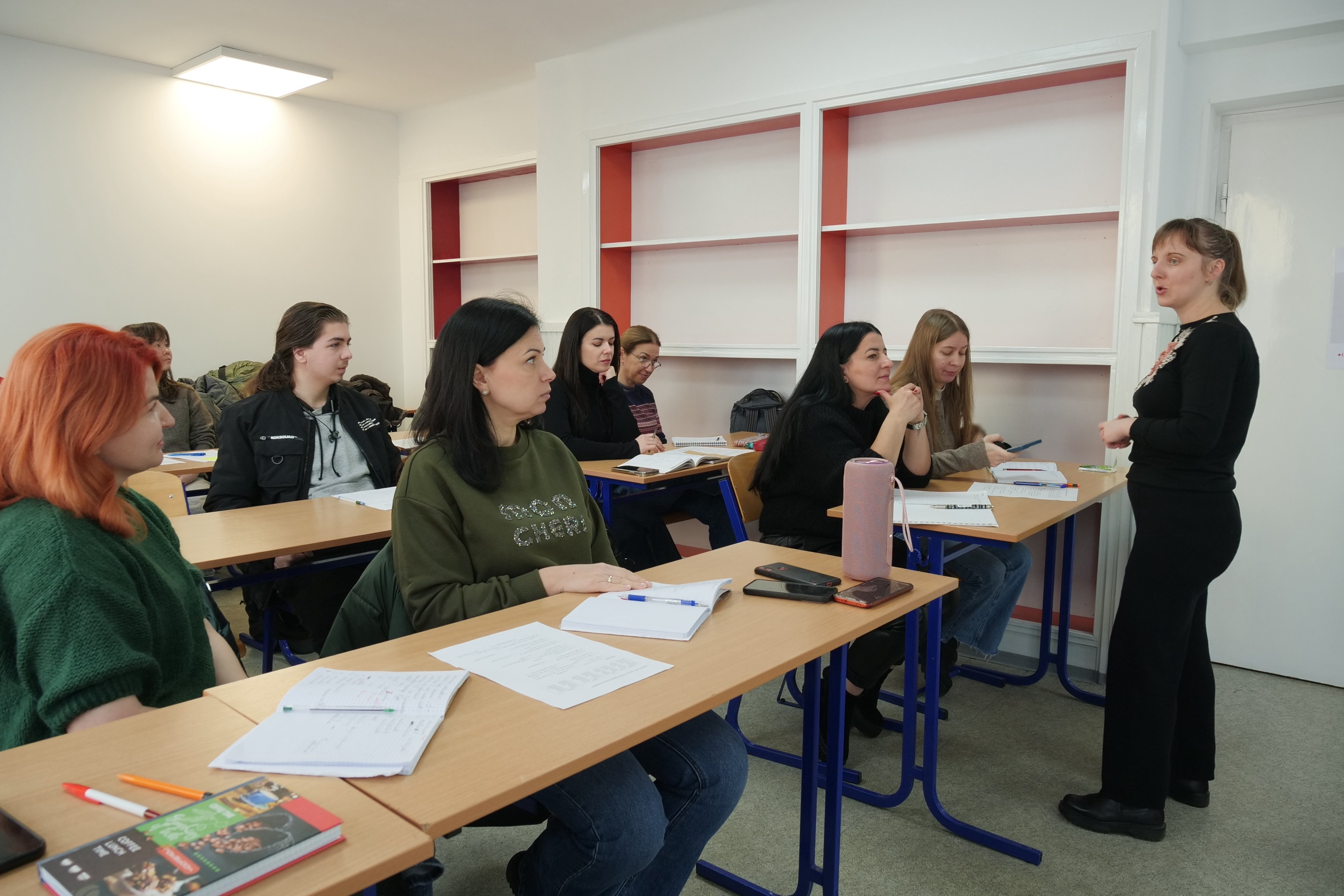 In this classroom, people who fled the escalation of conflict in Ukraine listen attentively to their teacher as part of Hungarian language classes offered by the Hungarian Red Cross.