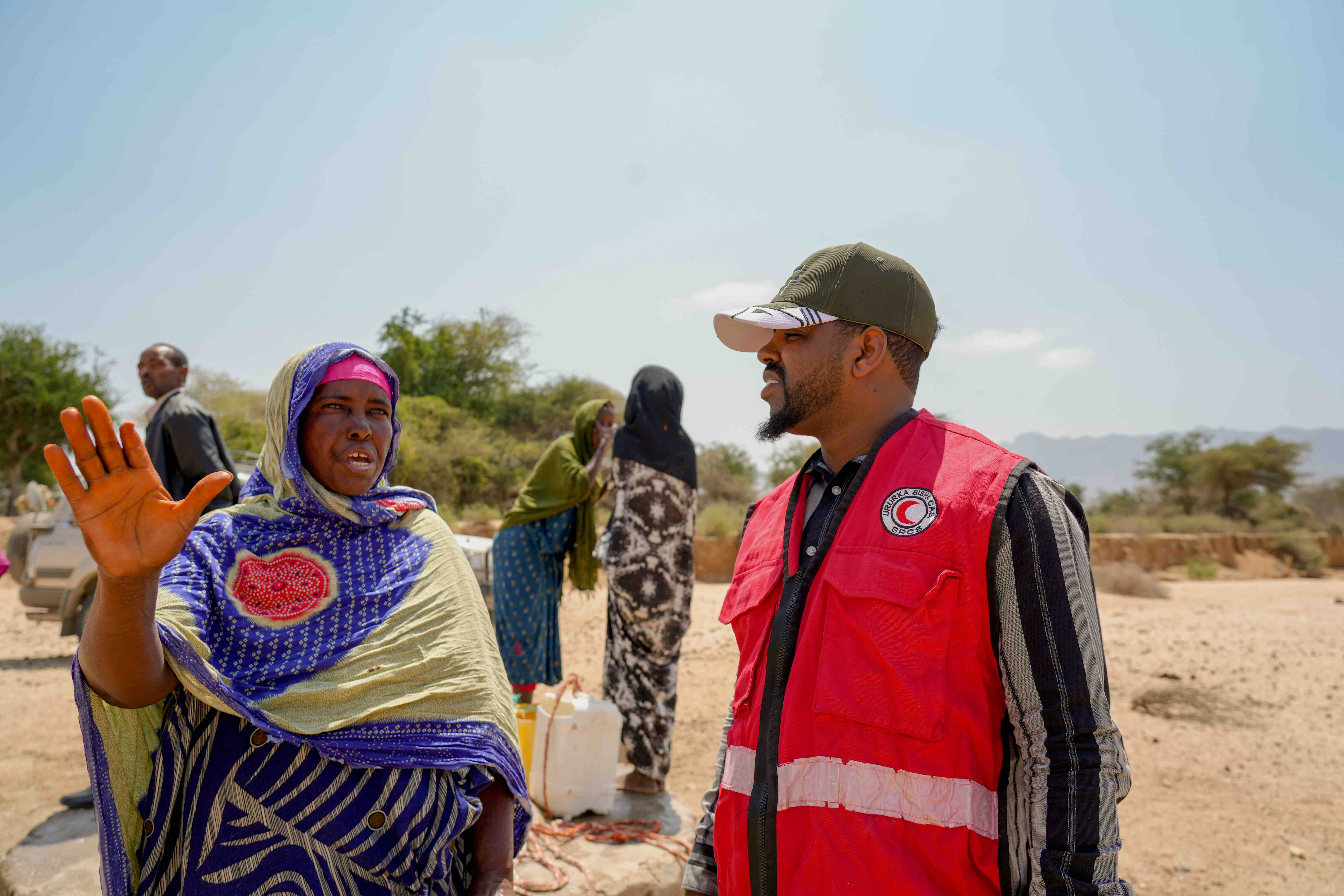 45-year-old Mama Mako Rooble Mataan explains the impacts of prolonged drought to a Red Crescent volunteer. "‘Our shallow wells are empty because the rains haven’t come for so long. Where can we even go?’ she asks. “There’s no better place to turn to—the same drought is everywhere.”