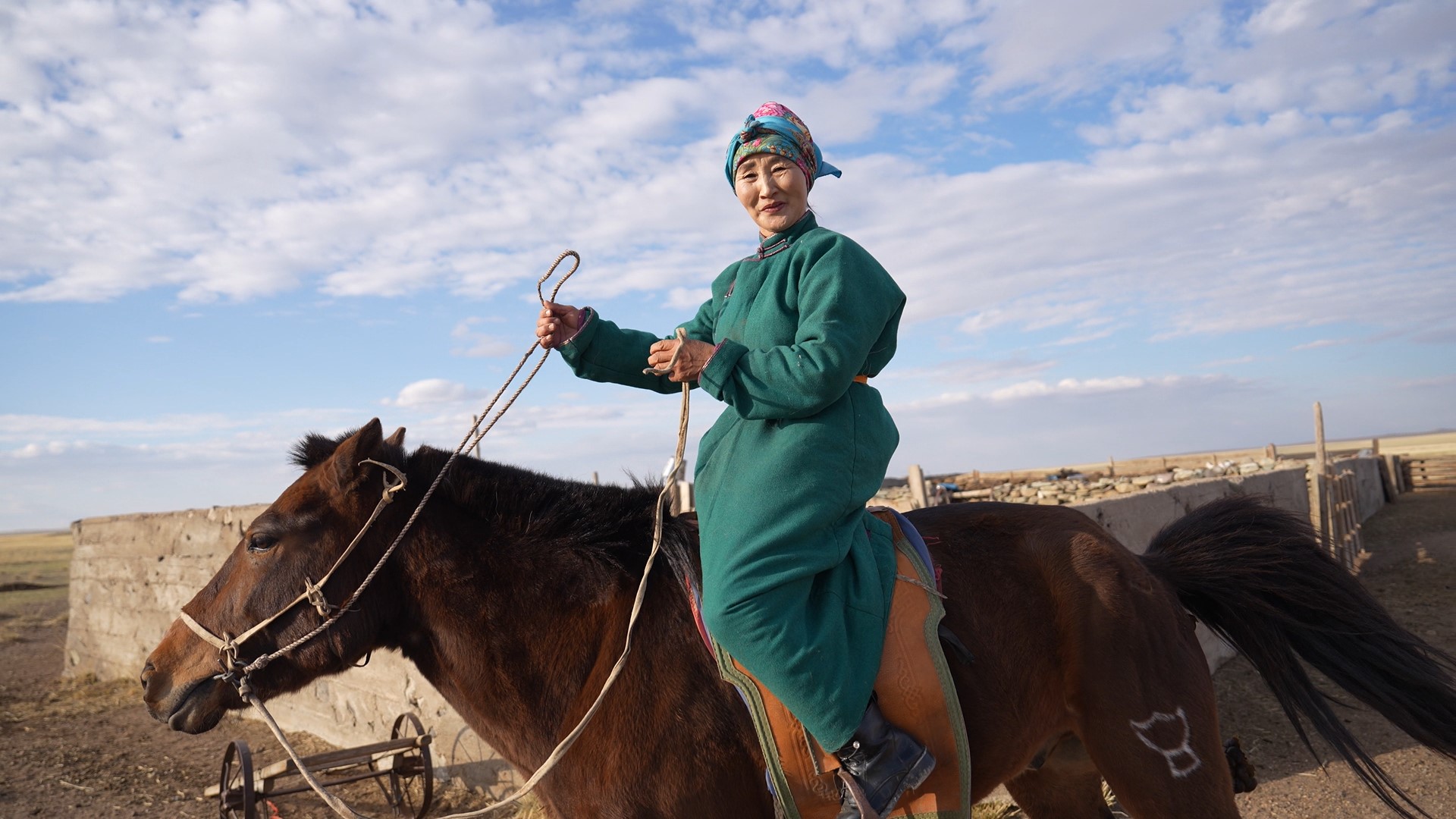 54-year-old livestock herder Altantuya Damdinsuren riding on the horse she uses to move her cattle to graze across vast grasslands in eastern Mongolia.