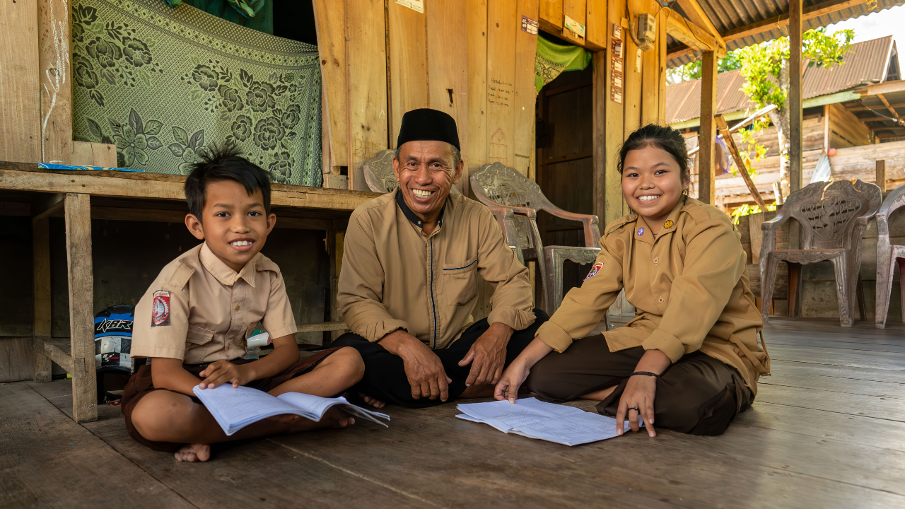 Najamuddin sits with his niece and nephew, who he cares for. Having healthy cattle means he can continue to provide for their daily needs and education.