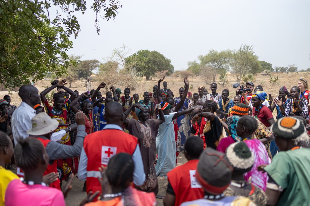 Women from Gakrol village in South Sudan dance and sing with South Sudan Red Cross staff and volunteers following the construction of a new borehole through the Programmatic Partnership.