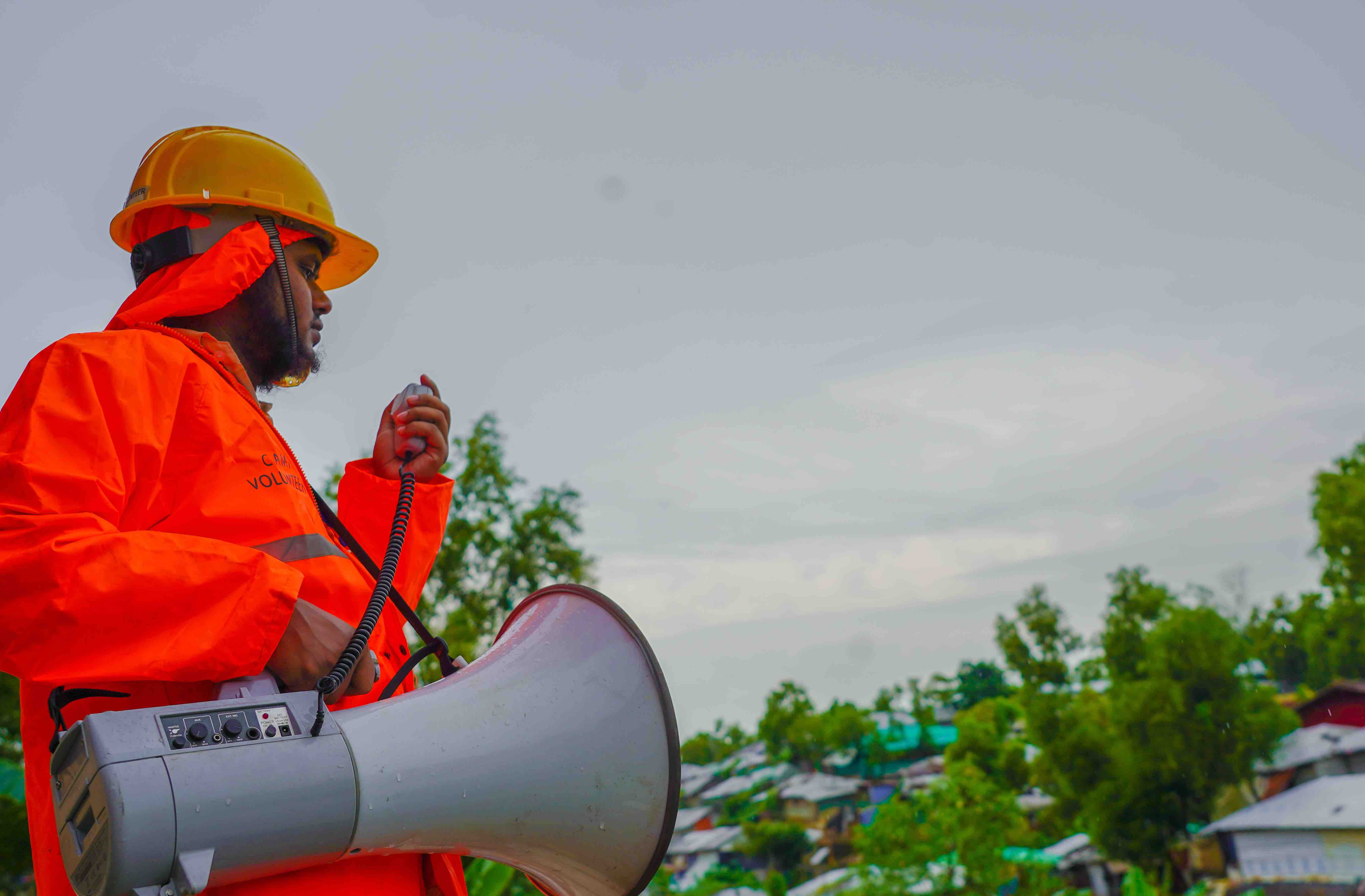A community volunteer in Bangladesh provides early warning messages to residents in camps for displaced people.
