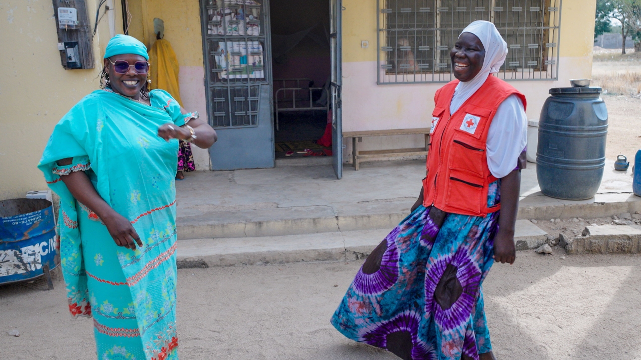 CP3 volunteer, Ramatou (right), laughs and smiles with Dr Laboulaye (left)- the head of the local health centre.