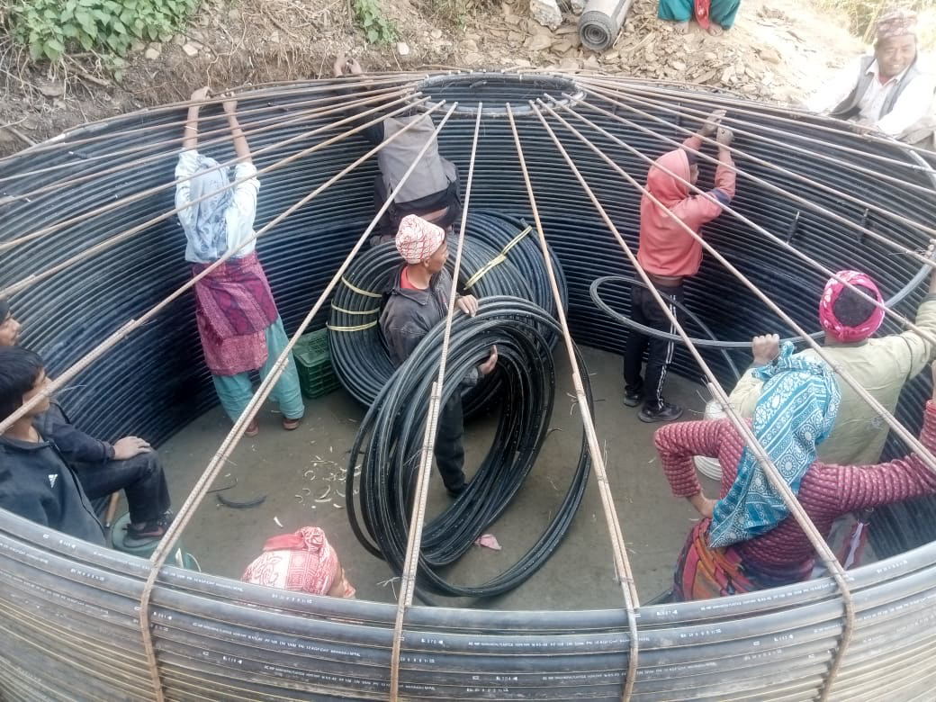 Members of a local water-user committee work with trained technicians and experienced water-system builders to build a water reservoir tank at Darma, Salyan, an area heavily impacted by the November 2023 earthquake.