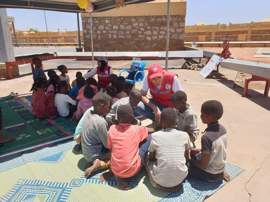 A volunteer takes part in games and activities with children, who make up a larger percentage of the Sudanese refugees arriving in Egypt.