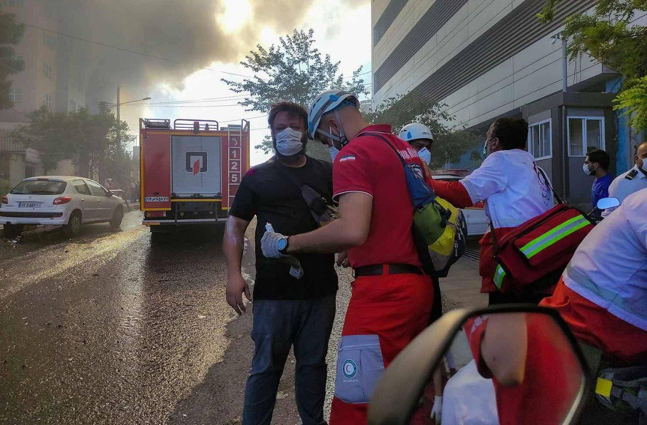 An Iranian Red Crescent emergency medical responder provides care for a man affected by recent attacks since the escalation of fighting between the State of Israel and the Islamic Republic of Iran.