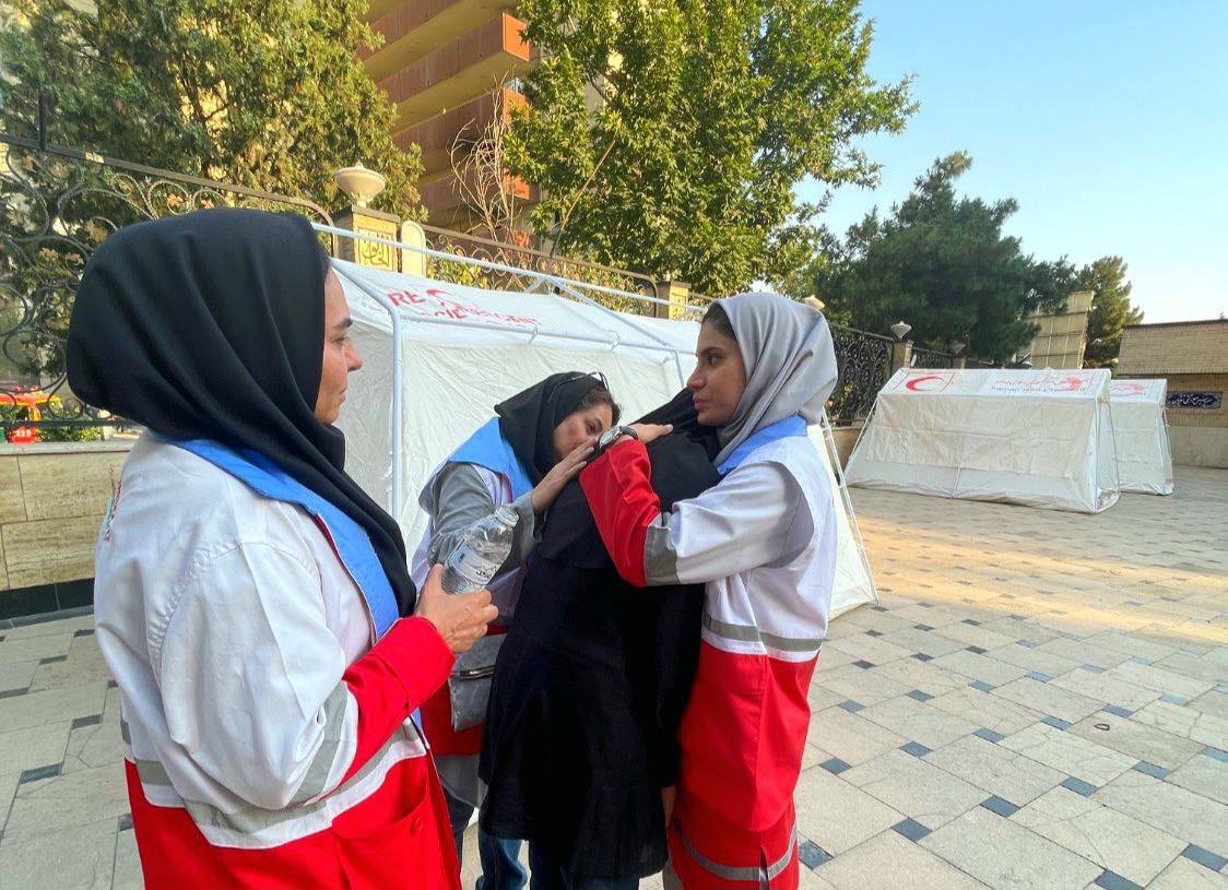 Members of an Iranian Red Crescent volunteer youth team provide psychosocial support to survivors of recent attacks since the June 13 escalation of hostilities.