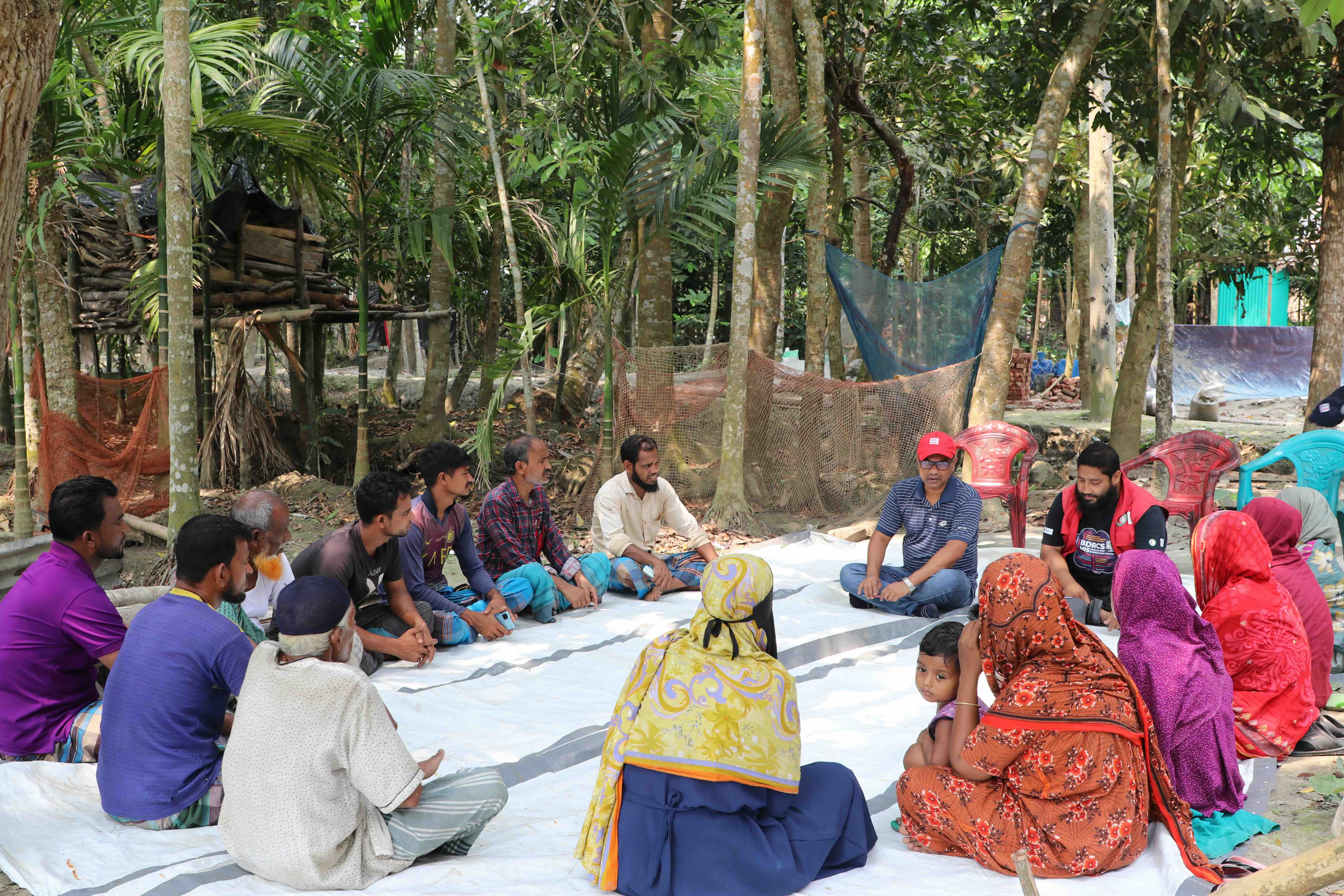 A member of the Bangladesh Red Crescent listens to residents who play a key role in the plannig and implementation of recovery and rebuilding efforts.