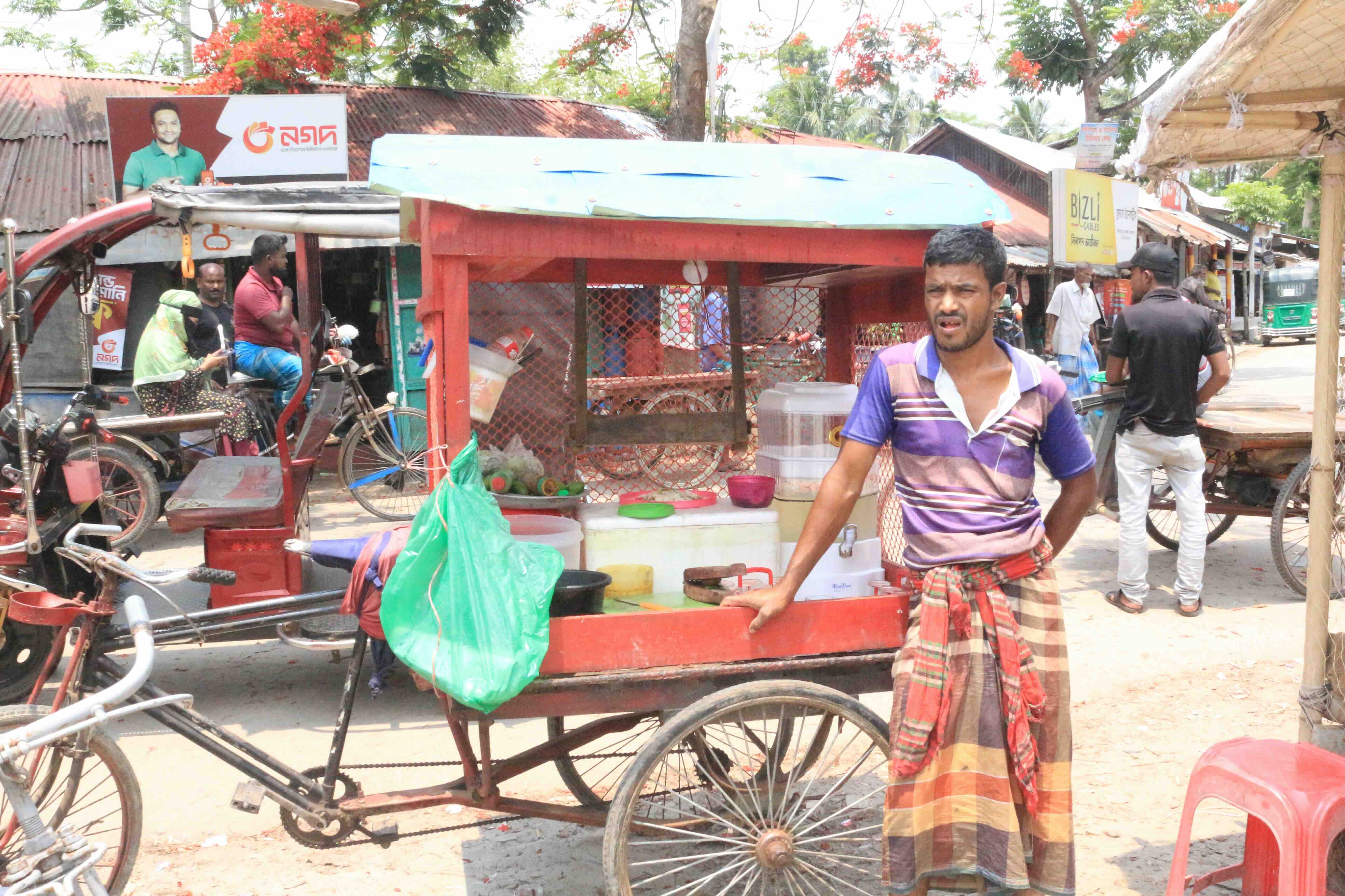 At a market not far from his home, Jahangir sells lemonade from his new three-wheeled, bicycle powered cart, which he was able to buy with the help of a cash grant from the Bangladesh Red Crescent and the IFRC. 