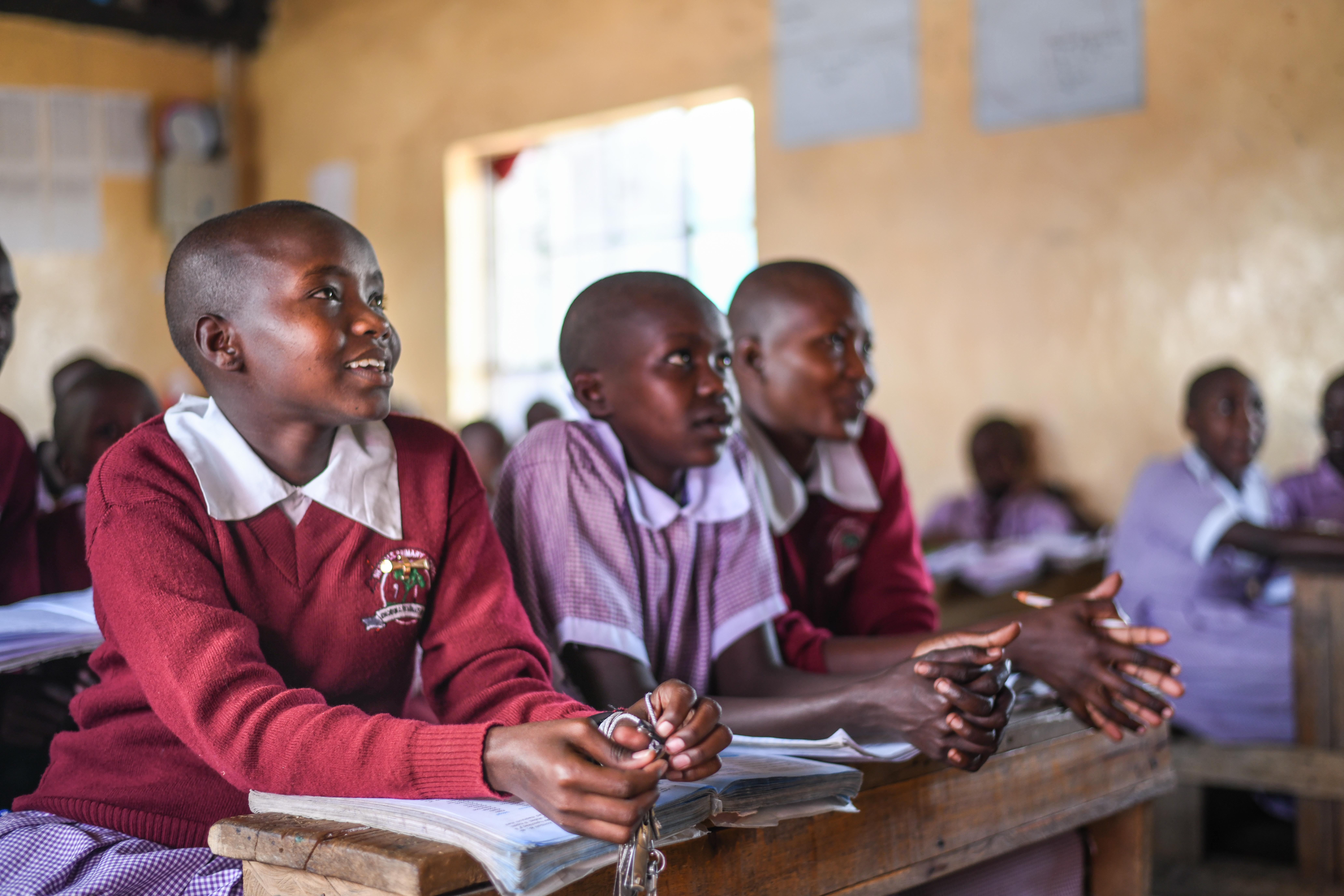 School health club members in Narok listen to teacher Peter as he explains different disease risks.