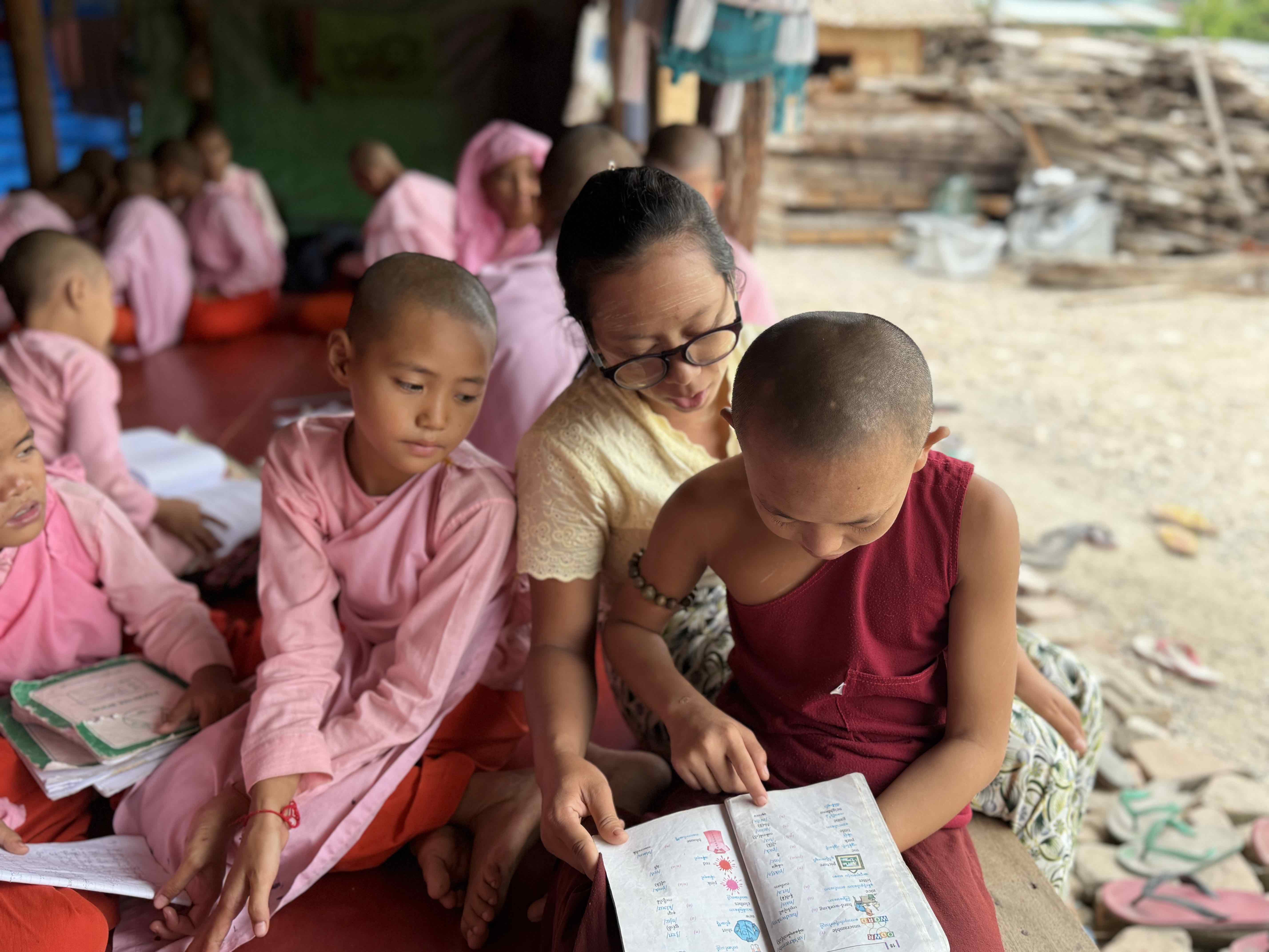 26-year-old teacher Khin Su Wai with her students at the Yadana Theingi Nun Monastery School in Sagaing region, which suffered severe damage and the loss of staff and students during the March 2025 earthquake in Myanmar.