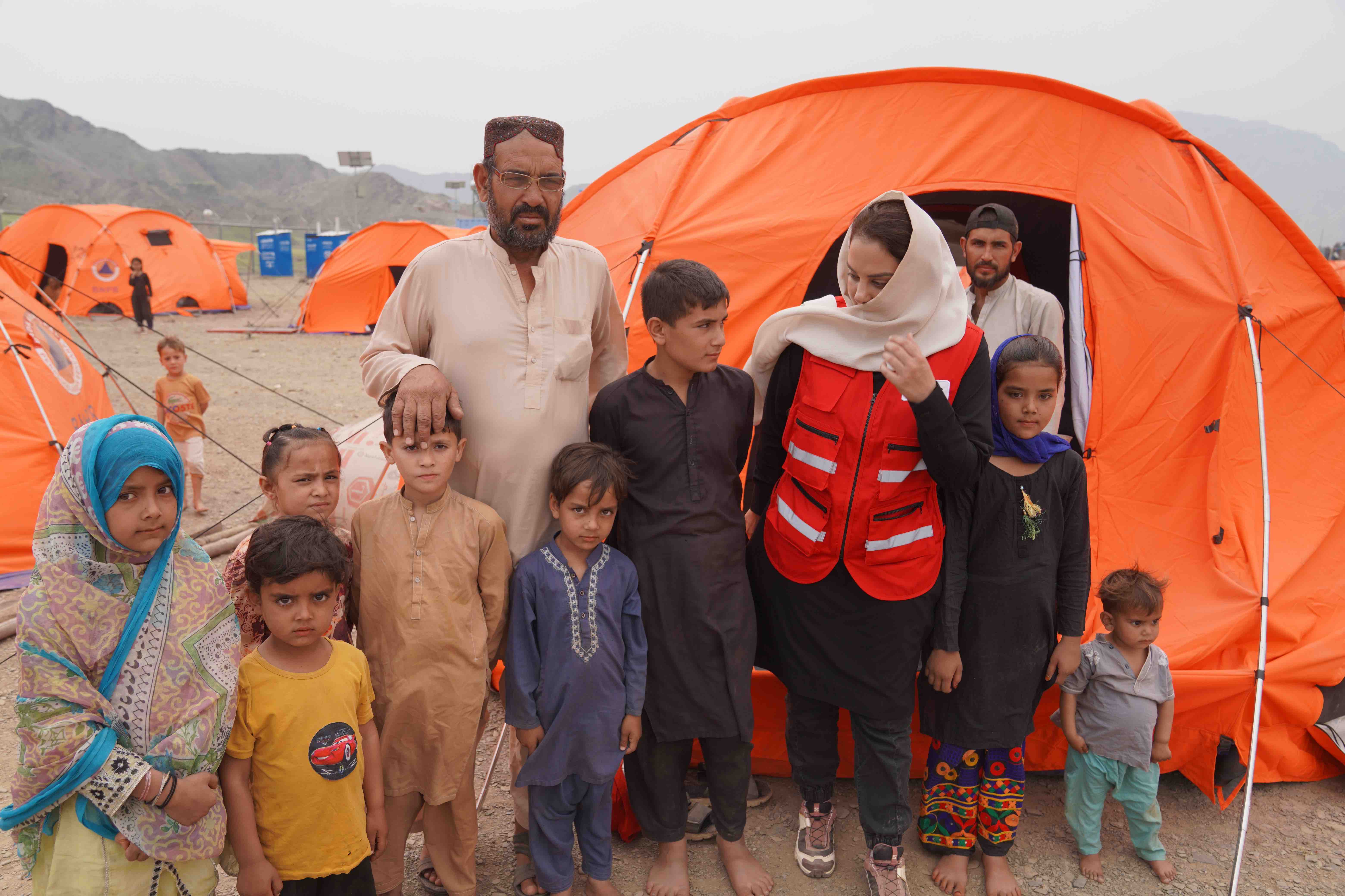 A former shopkeeper who had a small business in Karachi, Pakistan, Sadullah stands outside the tent where he has been staying with his five children at the Omari Camp for returnees in Nangarhar. 
