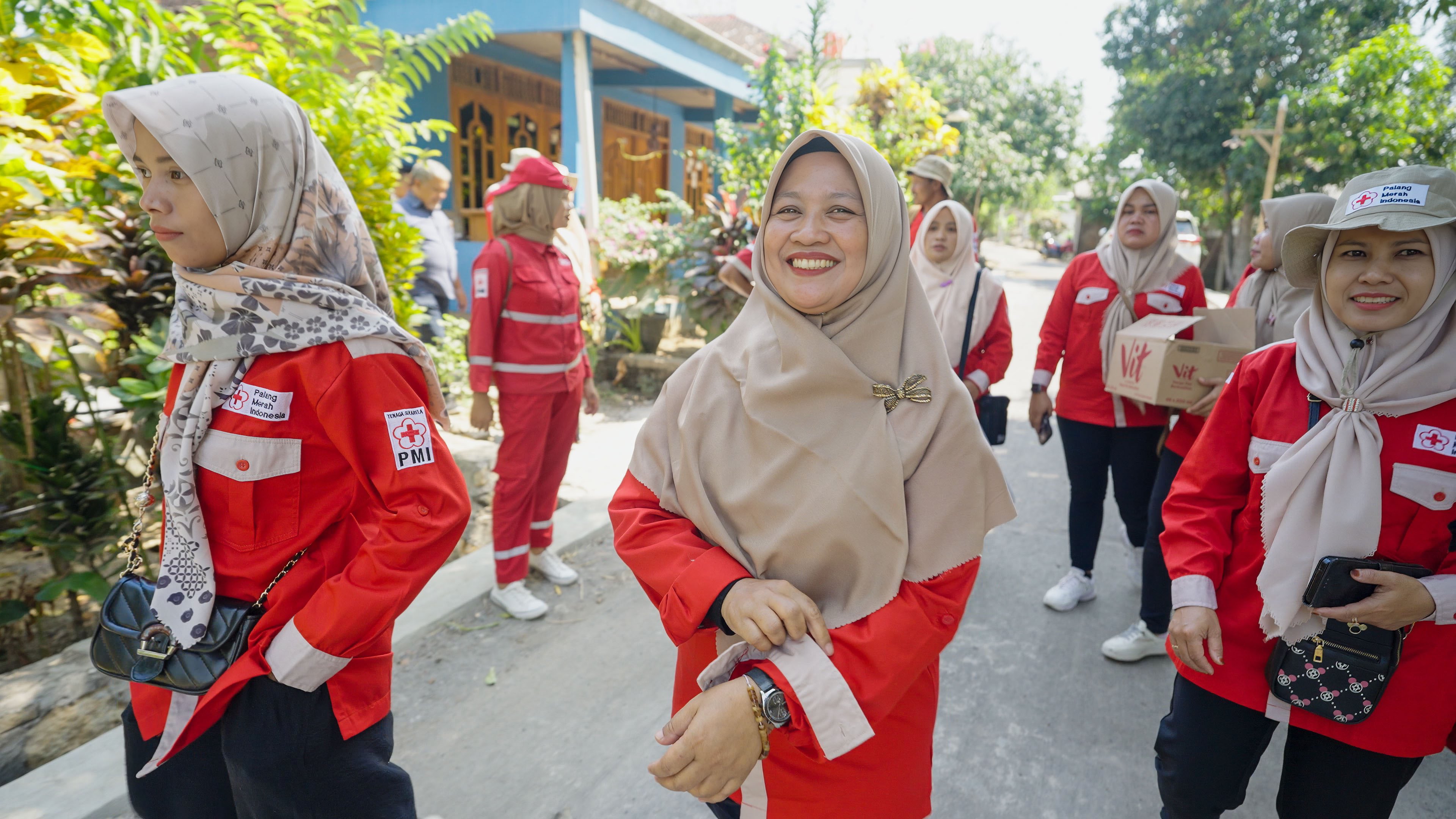 Bu Im heads out into her community after a meeting with fellow Indonesian Red Cross volunteers to update each other on disease risks in their villages.__