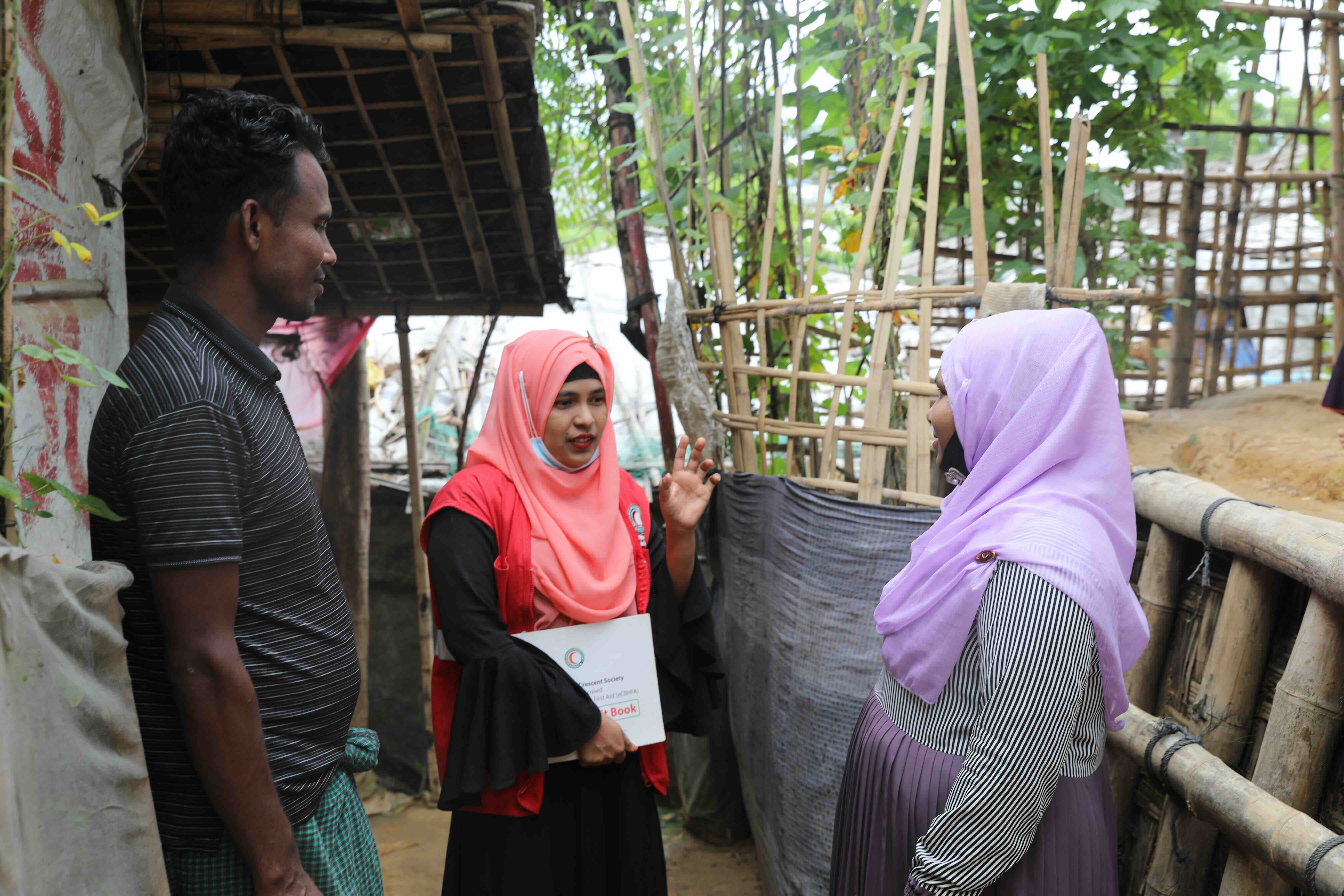 Camp volunteer Marijan (middle) with Sayedul Amin and Setara Begum. Marijan shares health and hygiene tips, as well as information about family planning. 