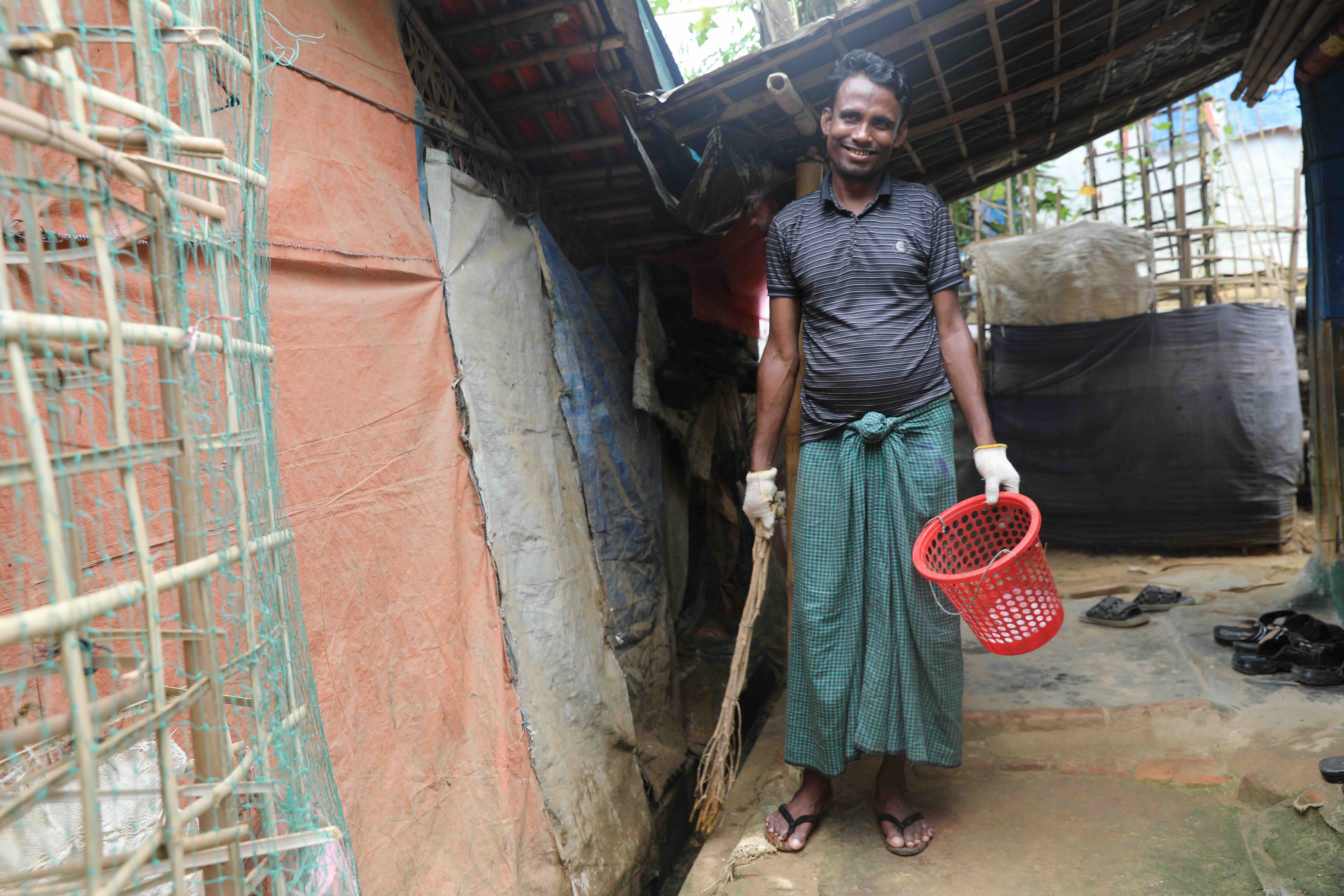 Sayedul Amin works everyday to keep his surroundings clean so his family can remain safe from diseases such as scabies and diarrhea. 