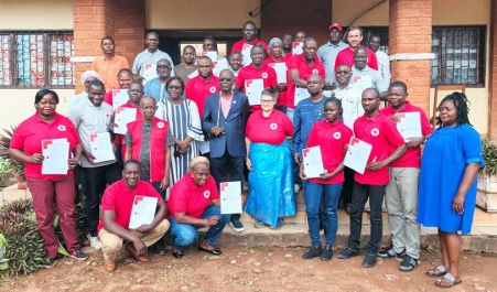 A group photo of Central African Red Cross volunteers and Belgian Red Cross trainers taken after a training session delivered by the Belgian Red Cross.