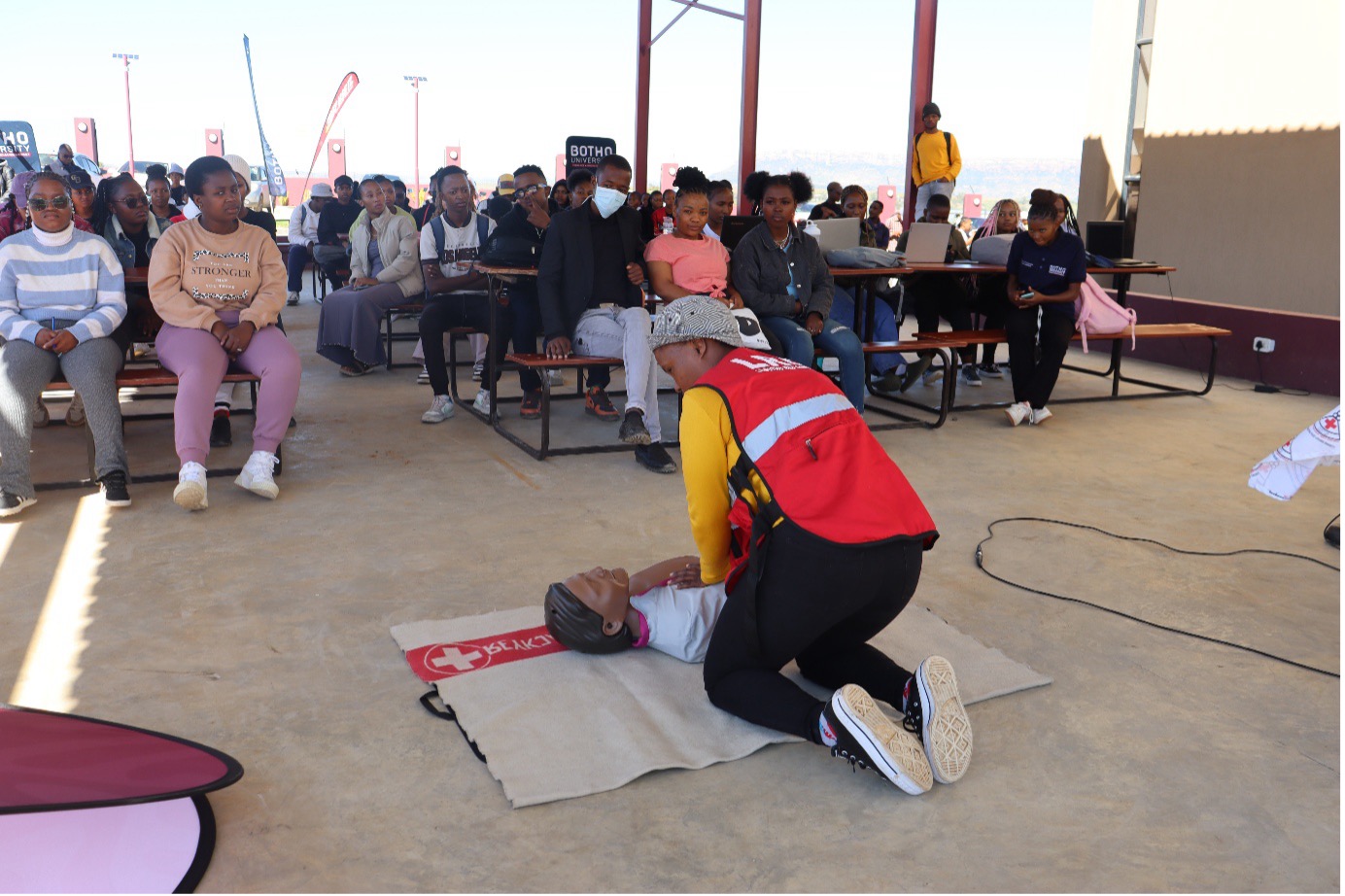A Lesotho Red cross volunteer demonstrates First Aid at Botho University.