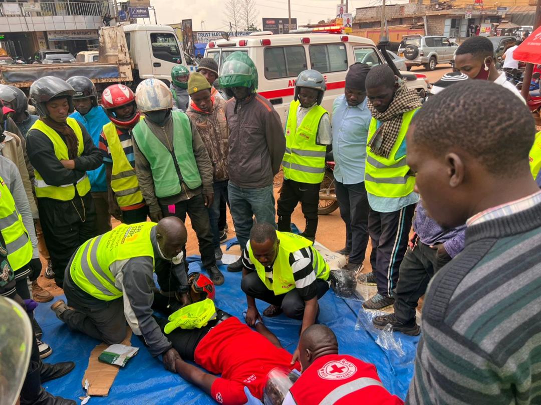 In a busy neighborhood of Kampala, volunteers from the Uganda Red Cross share life-saving first-aid techniques to motorcycle taxi drivers who frequently encounter road crashes and injuries on the city’s congested, chaotic streets.
